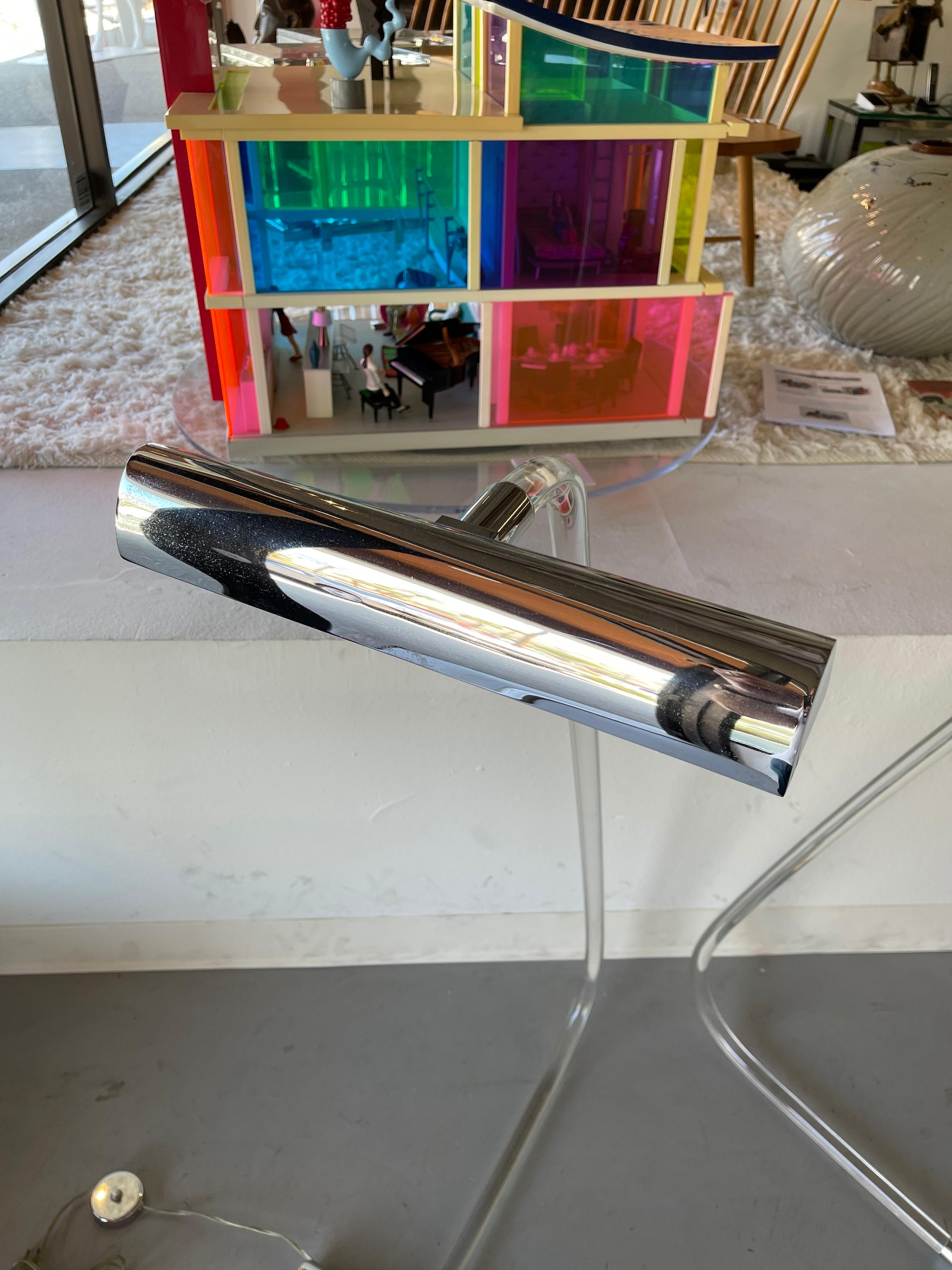 A pair of Lucite and chrome floor lamps designed by Peter Hamburger. These have been attributed to Knoll or Kovacs. Some wear to the chrome but in good vintage condition.