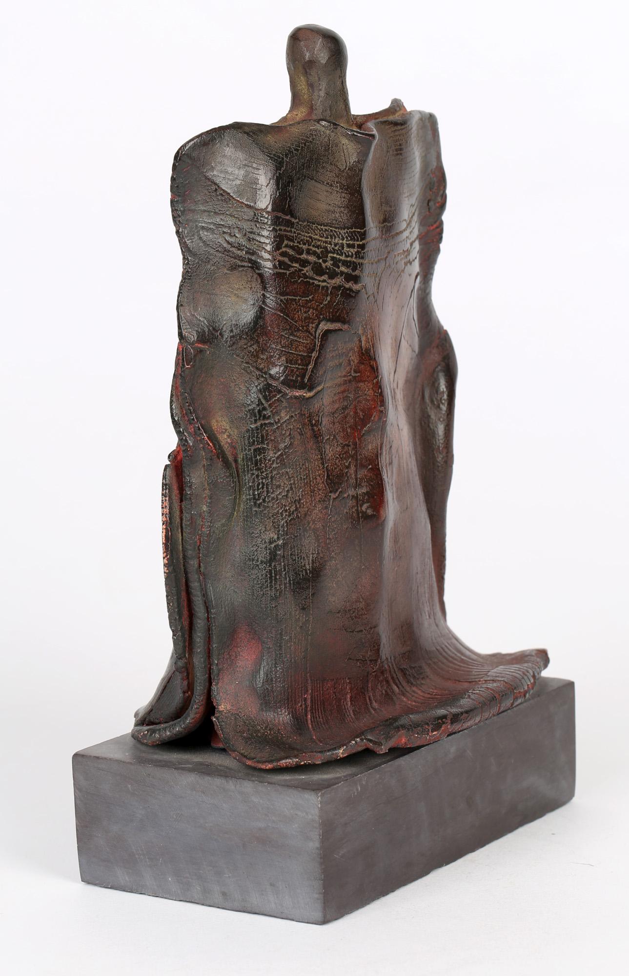 A very stylish studio pottery sculpture titled Mother and Child by renowned potter Peter Hayes and made around 1996. The sculpture is mounted on a rectangular slate base and is abstract in form with a mother holding her arm around a child who seems