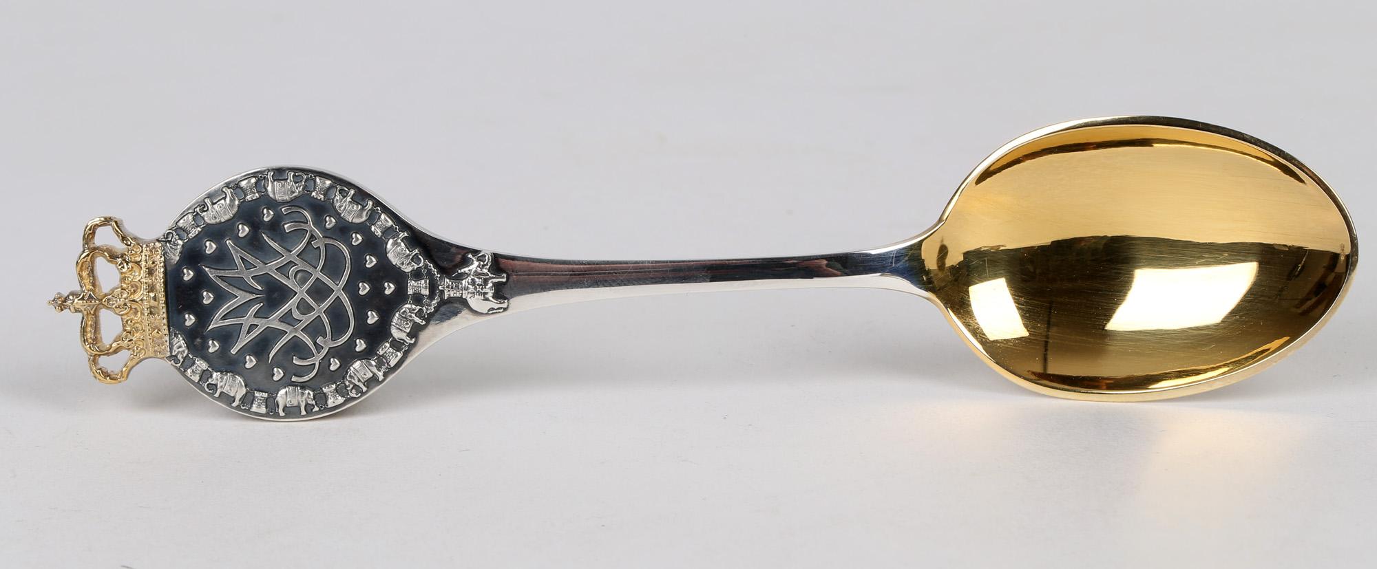 A very fine Danish Peter Hertz original boxed gilded silver spoon commemorating the silver wedding of Queen Margreth and Prince Henrik on 10th June 1992. The heavily made spoon has a rounded terminal relief moulded with a central monogram surrounded
