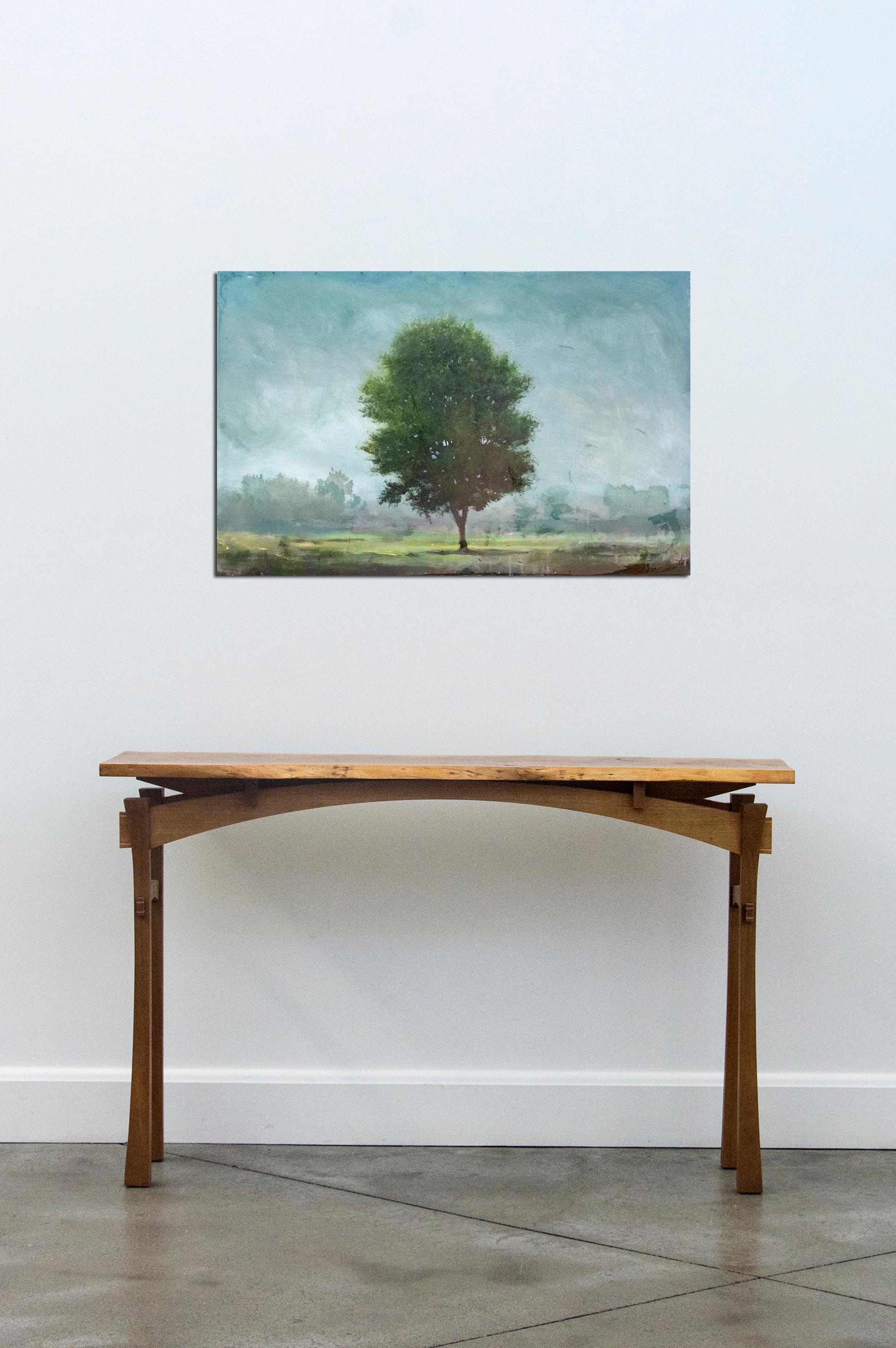 A lone tree is framed by steel blue sky in this emotive landscape by Peter Hoffer. Hoffer's trompe l'oeil and scumboling techniques are reminiscent of those of British landscape painter John Constable. The work is finished with a layer of resin and