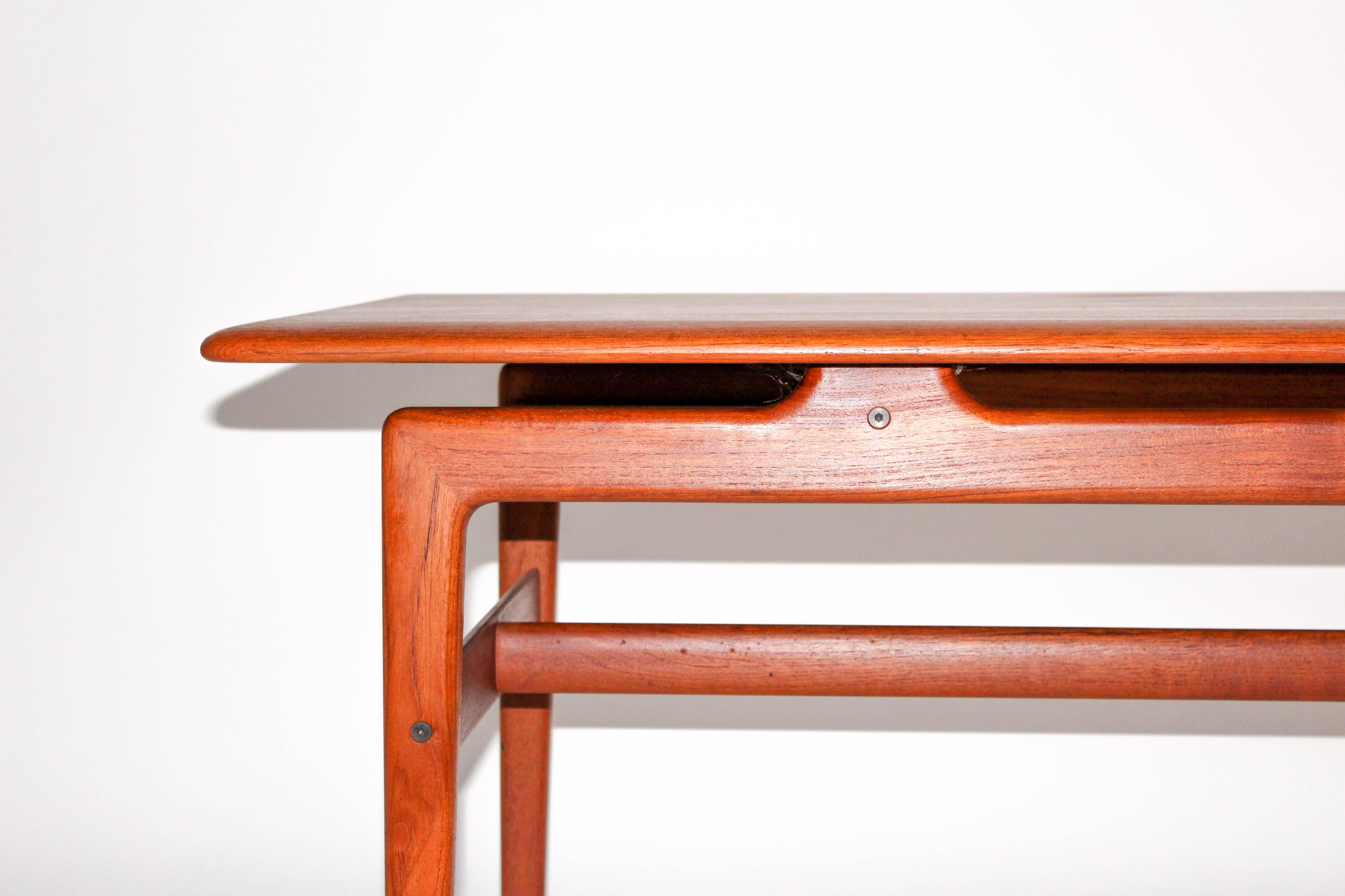 Solid teak coffee table by Danish designers Peter Hvidt and Orla Mølgaard Nielsen. The table has very nice details and shapes. It is in very good vintage condition with some minor signs of usage. 

