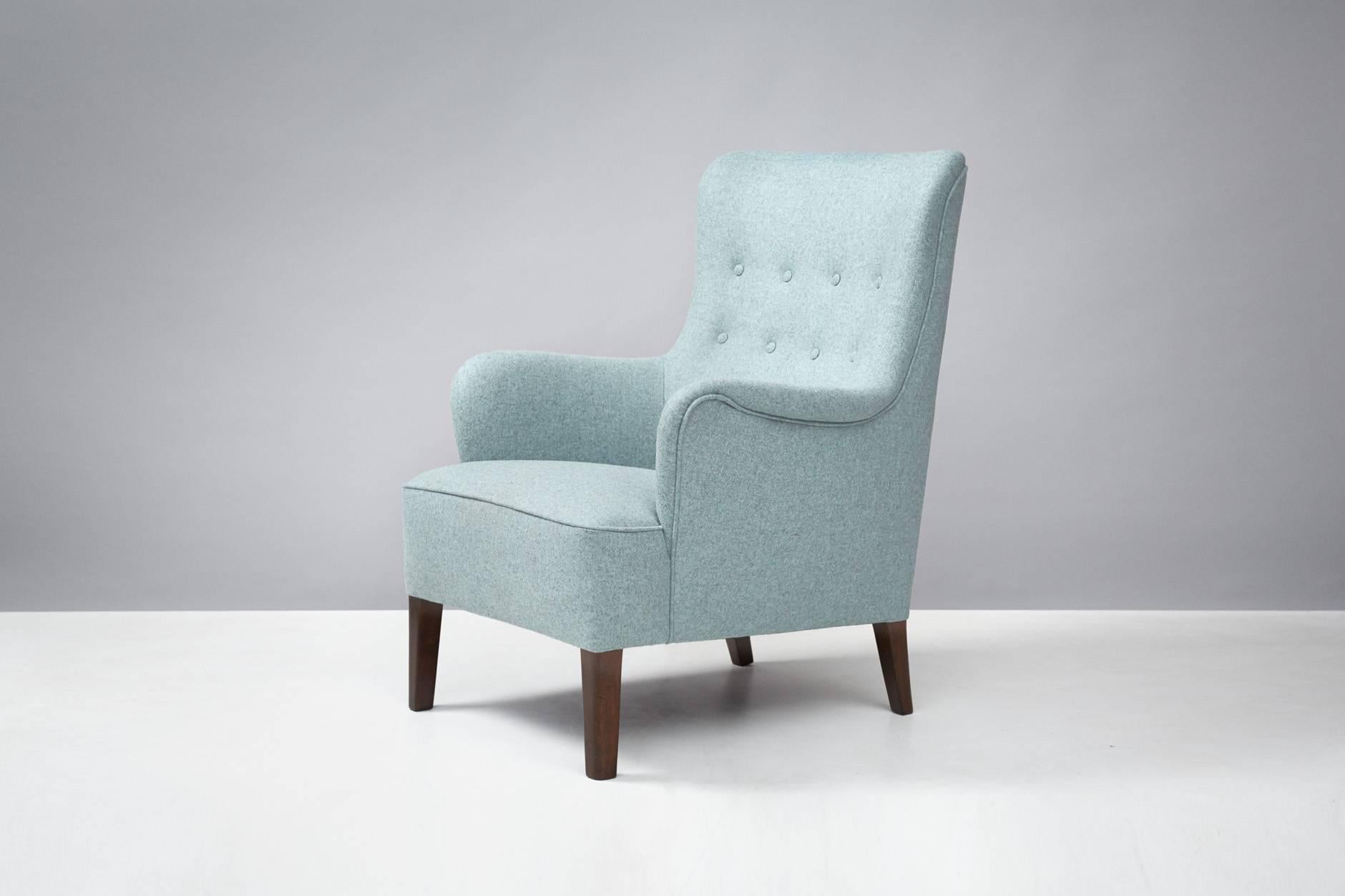 Produced by Fritz Hansen, Denmark. Reupholstered in Melton wool fabric from Abraham Moon. Stained beech legs.
 