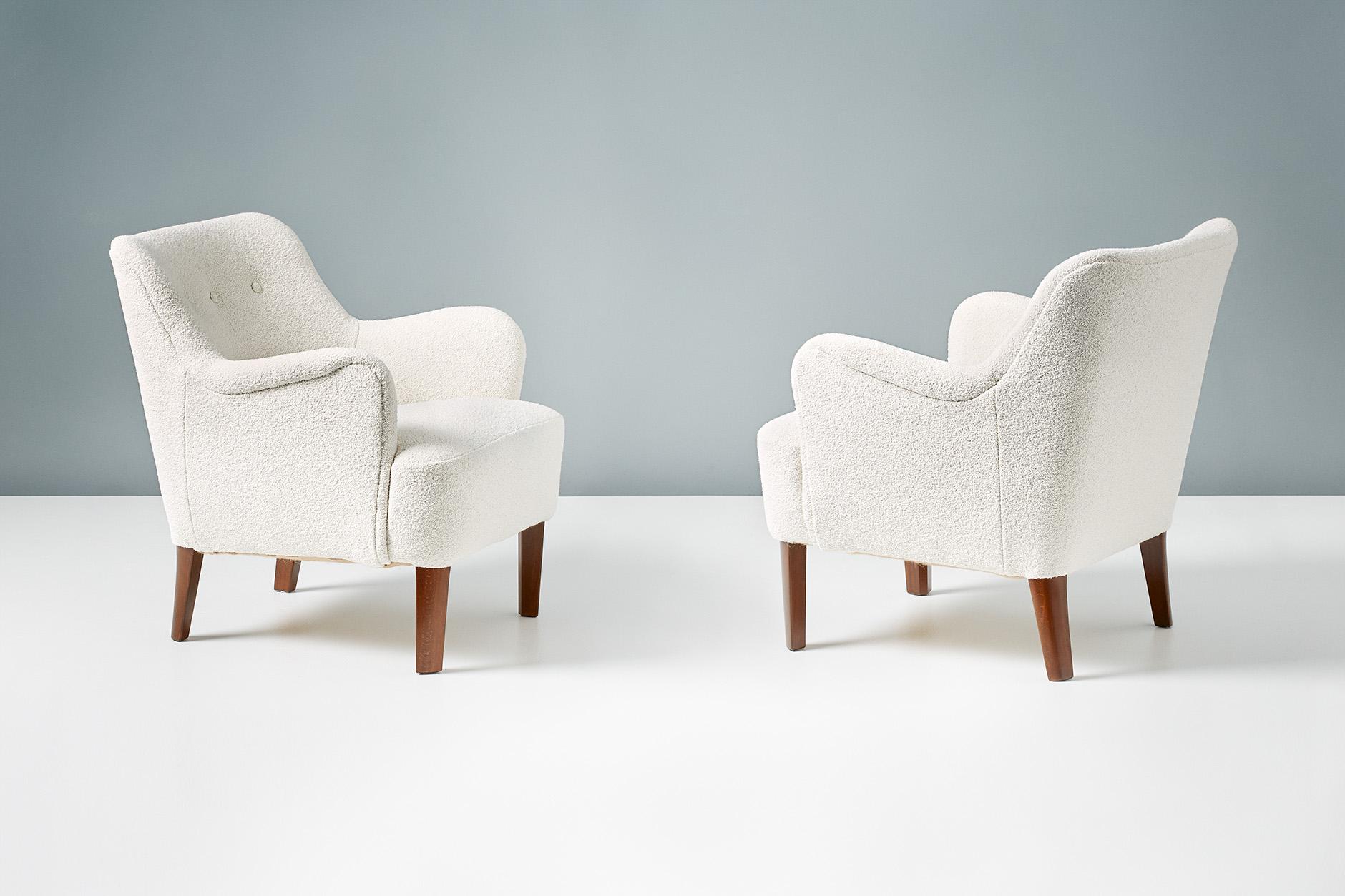 Peter Hvidt.

Model 1748 lounge chairs, circa 1940s.

These elegant low-back lounge chairs were produced by Fritz Hansen in Denmark in the late 1940s by master designer Peter Hvidt. The beech legs have been walnut-stained and both chairs have