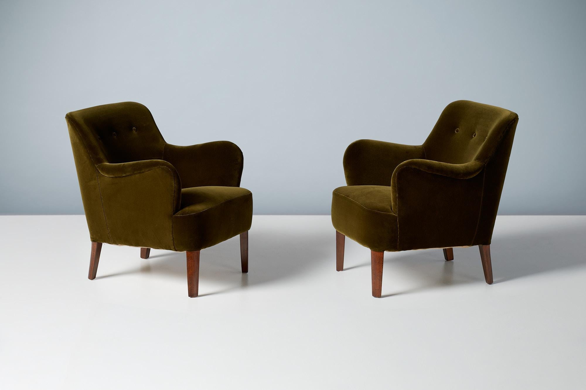 Peter Hvidt - Model 1748 Lounge Chairs, circa 1940s.
These elegant low-back lounge chairs were produced by Fritz Hansen in Denmark in the late 1940s by master designer Peter Hvidt. The beech legs have been walnut-stained and both chairs have been