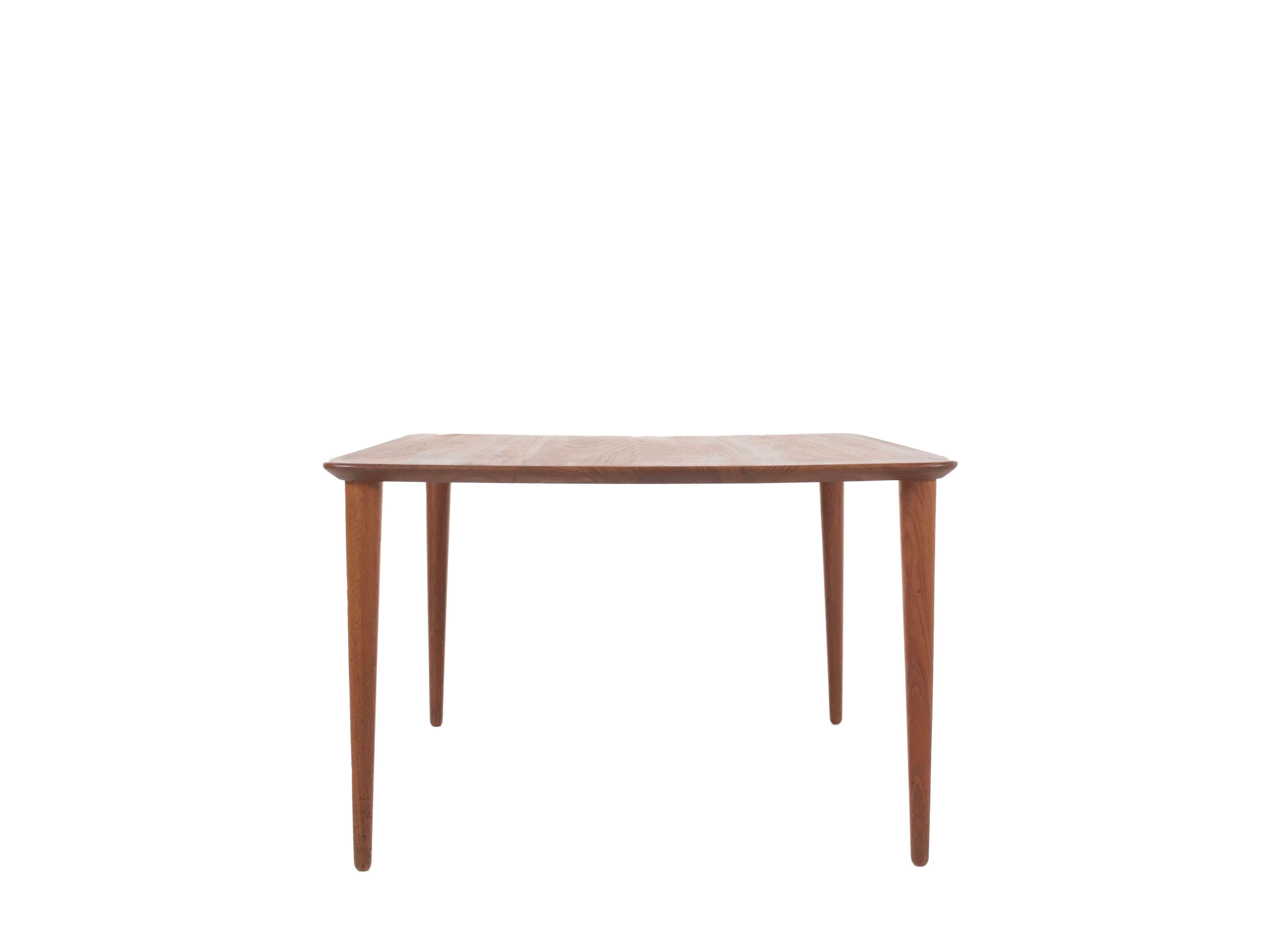 Nice Peter Hvidt and Orla Mølgaard teak coffee table for France & Son from Denmark the 1960s. This table has a minimalistic design, however is elegant due to the usage of the round edges and the cone shape of the legs. It is very practical to use