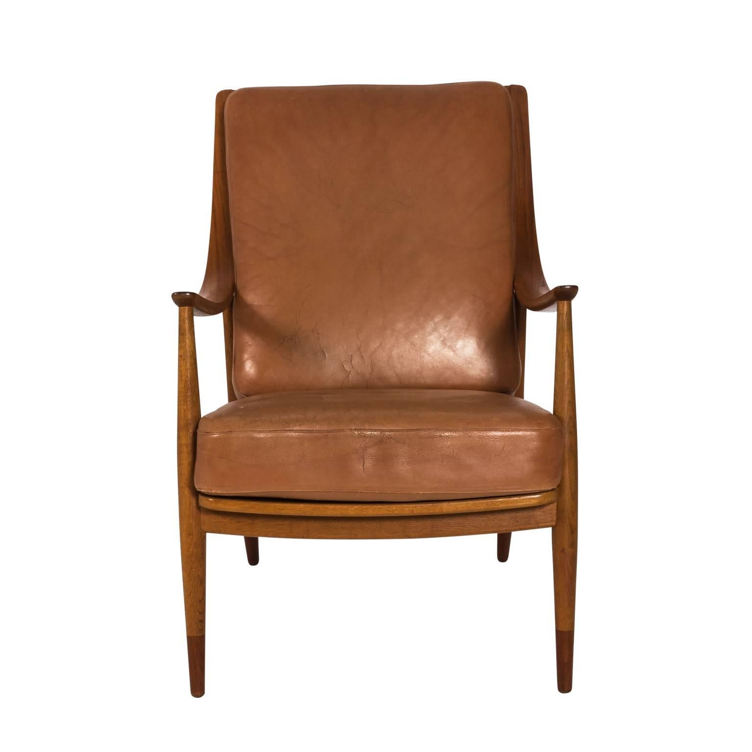 Classic chair by Peter Hvidt and Orla Mølgaard, the Danish design duo, circa midcentury. Well balanced teak frame with complementing leather seat creates an ideal balance of form and function.
 