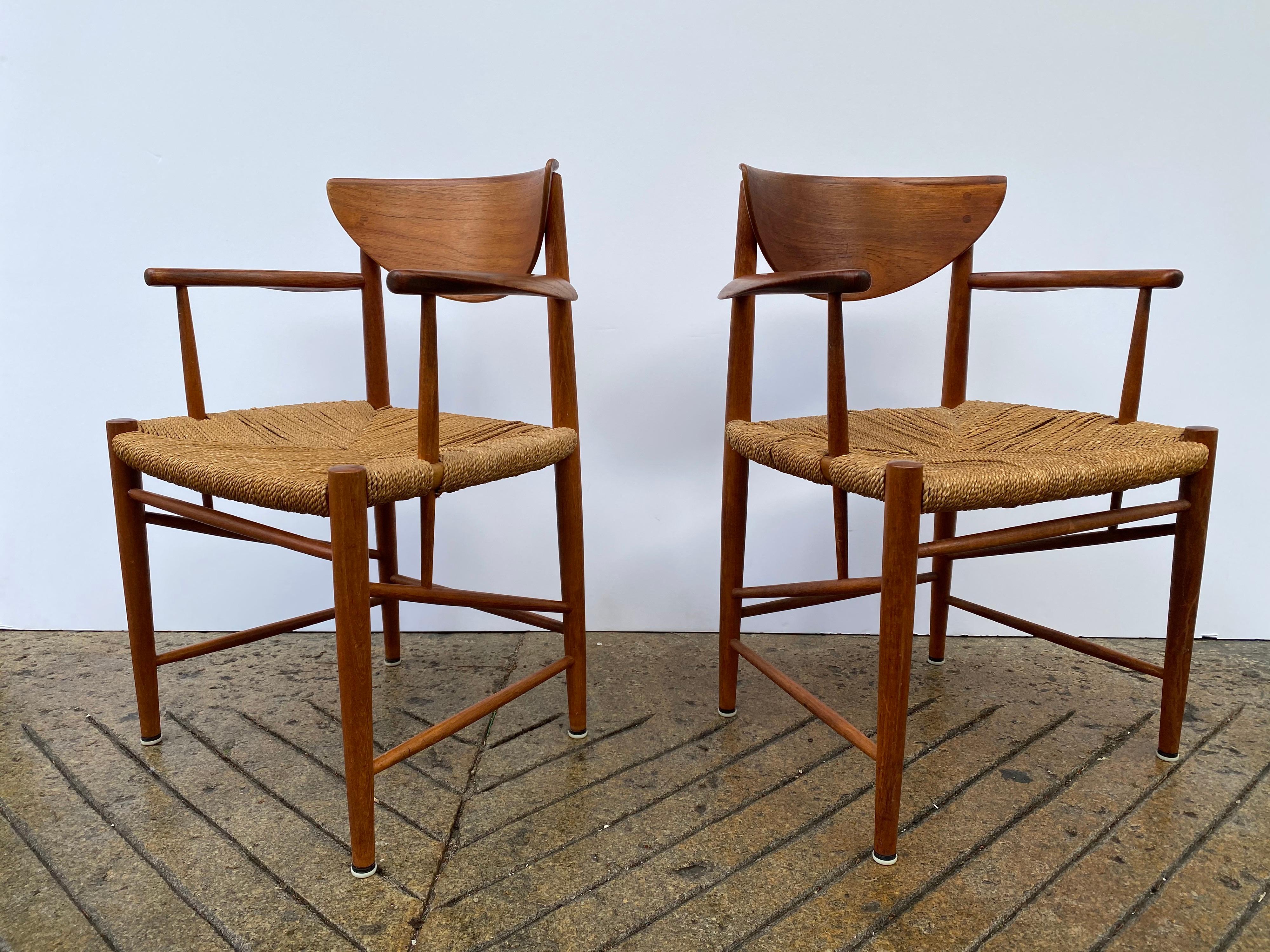Pair of Peter Hvidt armchairs in solid teak. Beautiful chairs, very original, one seat shows a little more wear than the other. Wood is very nice! Chairs are very solid. One piece re-glued on back of seat back as seen in photo.