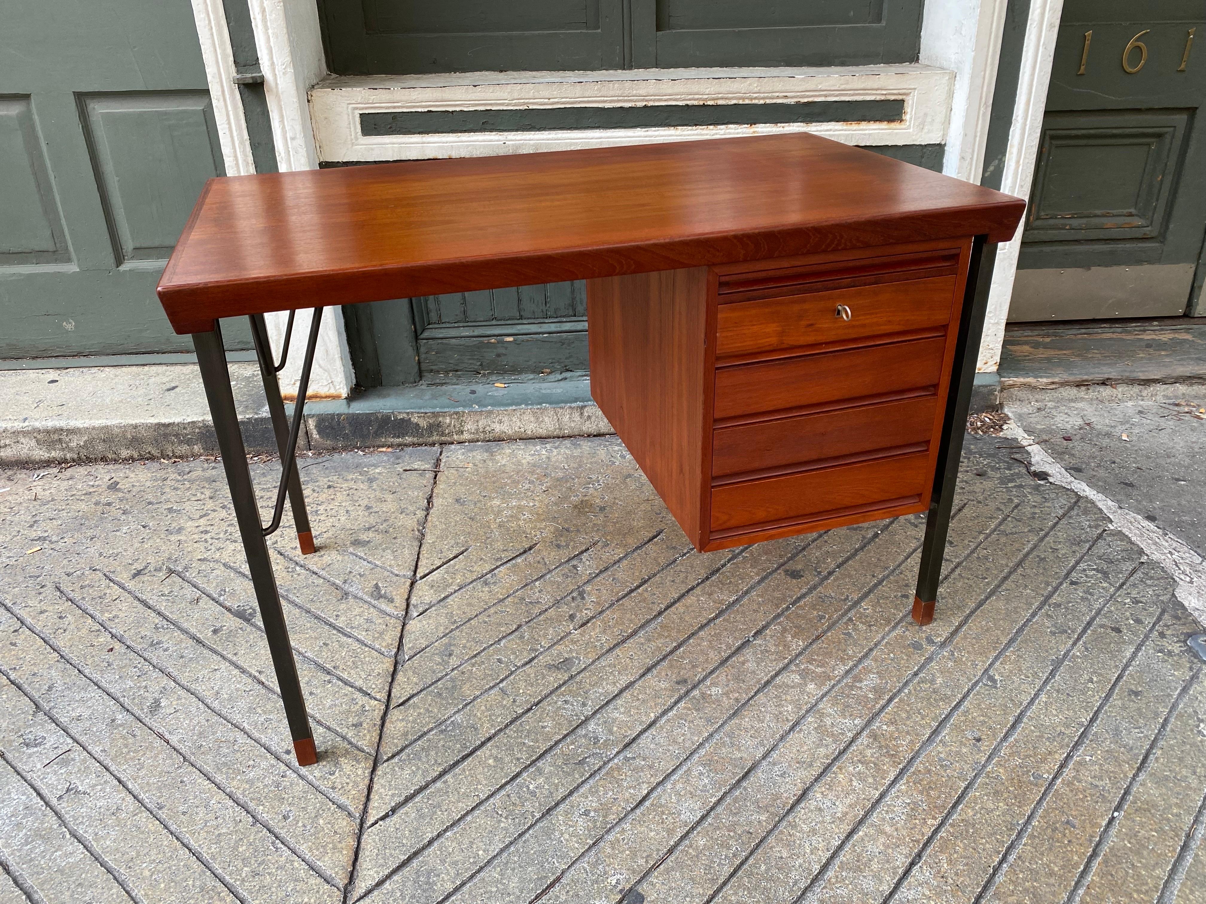 Peter Hvidt and Orla Molgaard-Nielsen Teak Single Bay Teak Desk.  Solid Teak with a Locking Drawer.  Iron legs with Teak Caps.  Top shows a shadow from a Desk Pad, but over-all very clean and in nice condition!  Check out my other listing for the