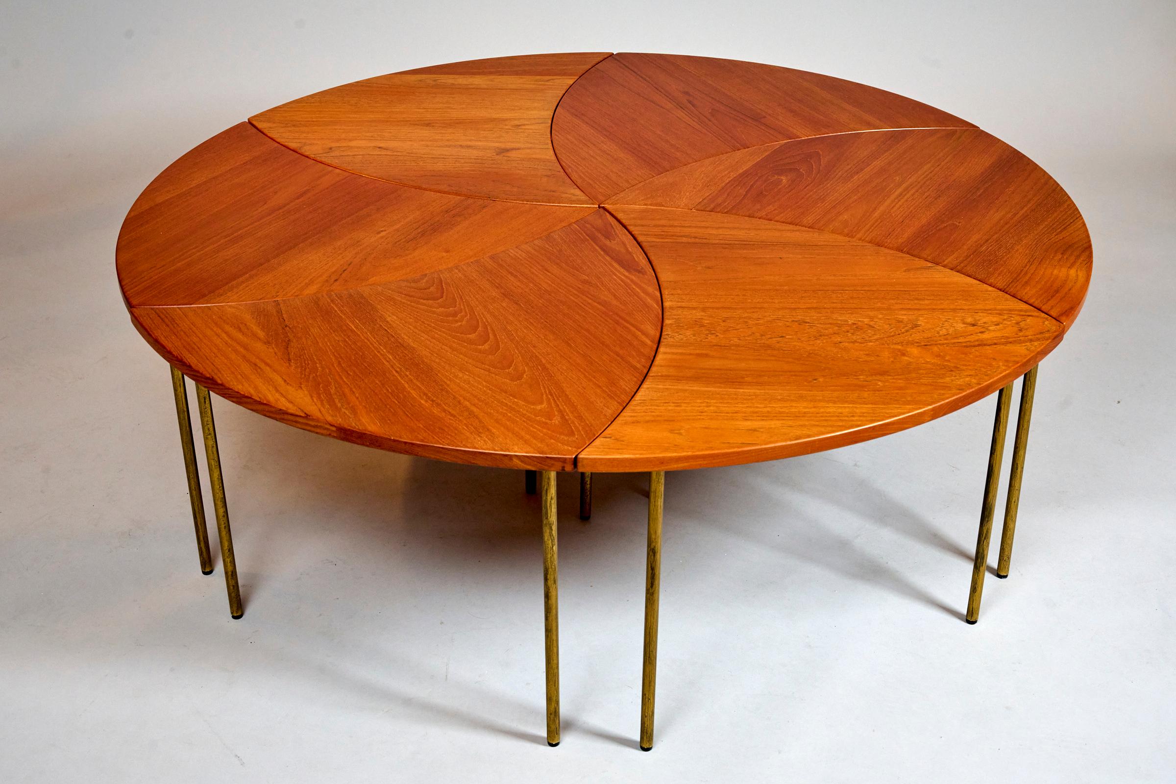Original 'pinwheel' table by Peter Hvidt and Orla Molgaard. 
Denmark 1953

Solid teak with brass legs.

Comprises of six individual tables which can be configured in a variety of shapes... the tables can be used as large central table or