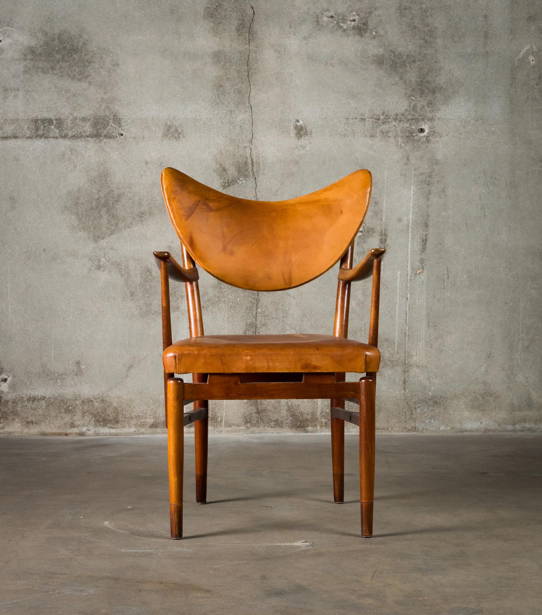 A leather and stained beechwood armchair by Peter Hvidt, Denmark, circa 1955.