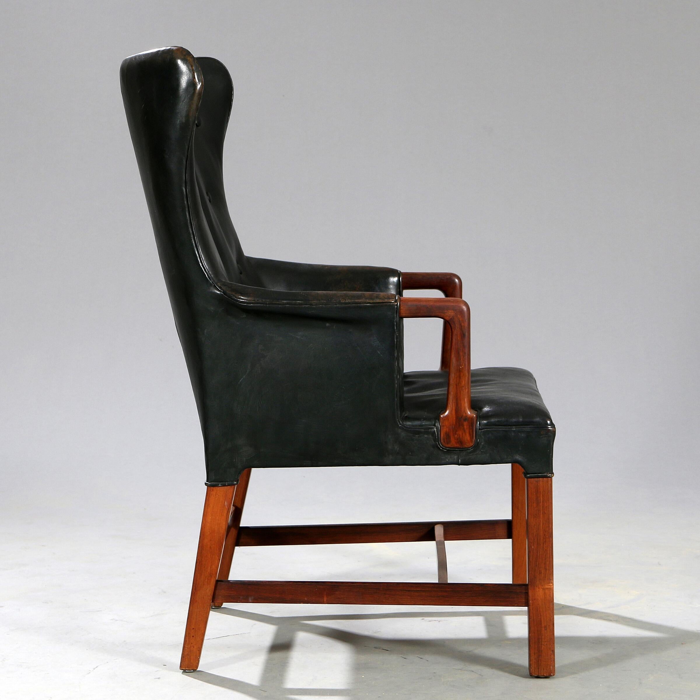 Easy chair with Brazilian rosewood frame. Seat, sides and button fitted back upholstered with black leather. Made by cabinetmaker Thorald Madsen.

Literature: Grete Jalk [ed.]: “40 Years of Danish Furniture Design”, similar chair ill. vol. 2, p.