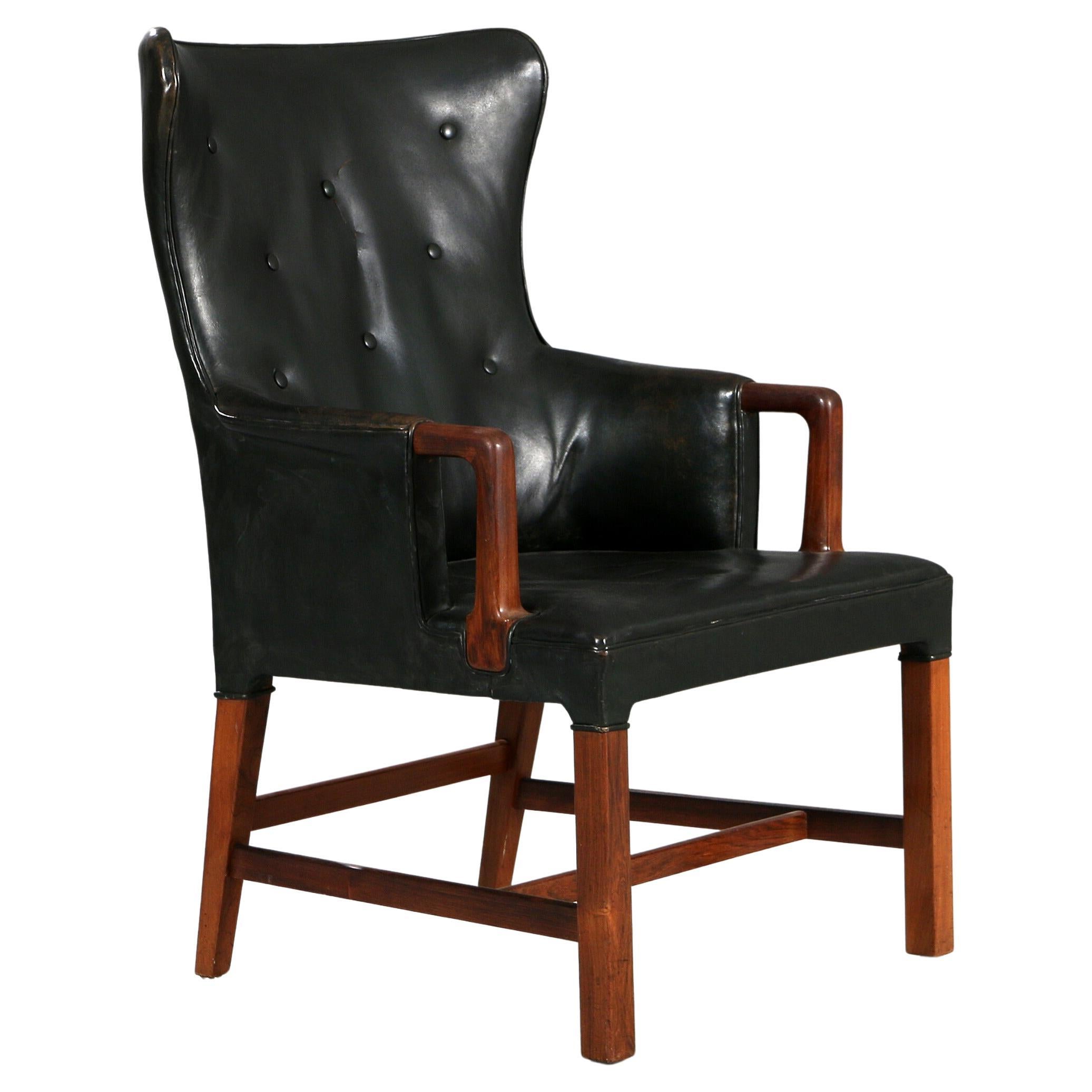 Peter Hvidt: Armchair of Rosewood and Black Leather circa 1955 For Sale