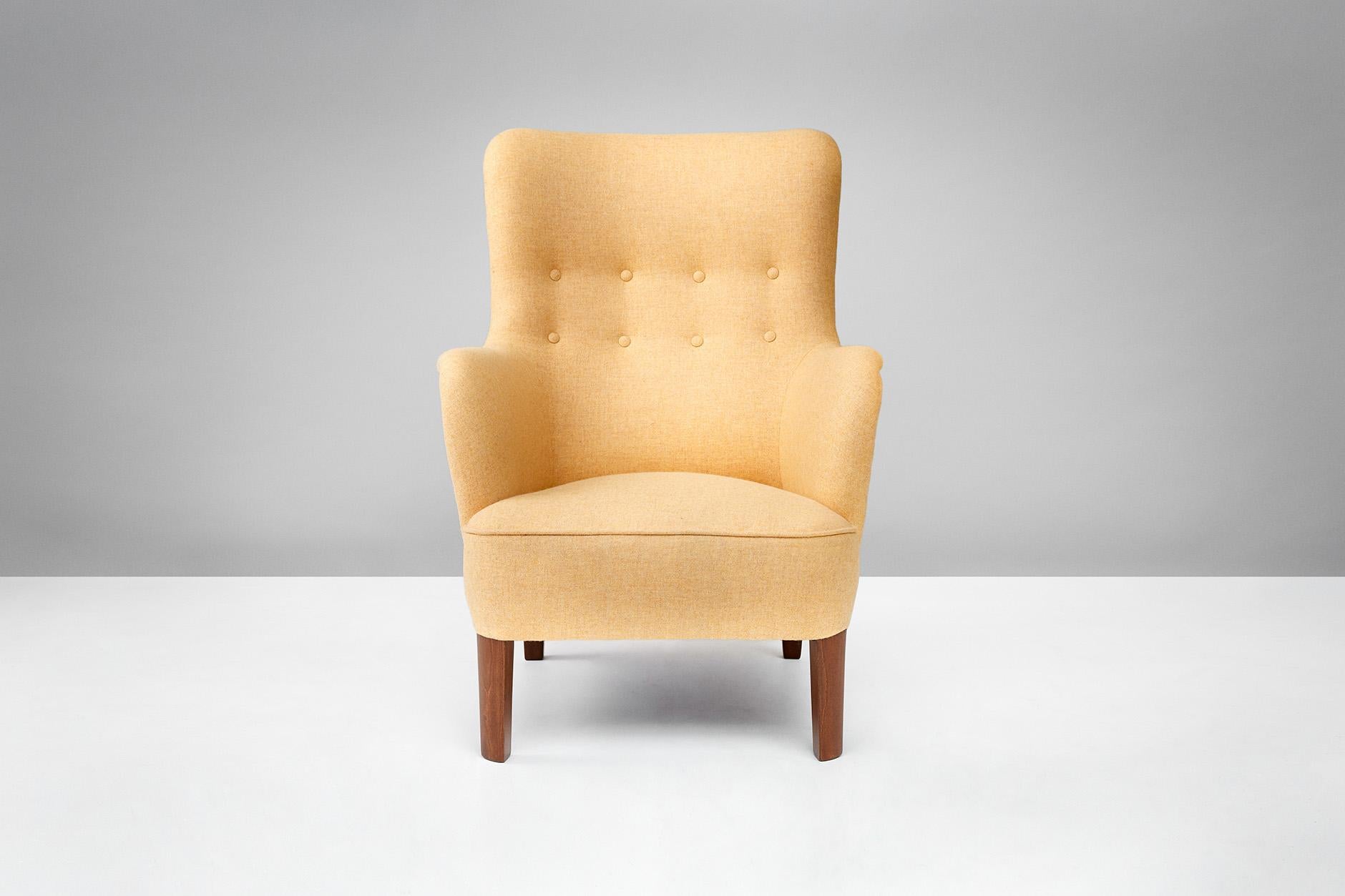 Produced by Fritz Hansen, Denmark, circa 1940s. Reupholstered in Melton wool fabric from Abraham Moon. Stained beech legs.
 