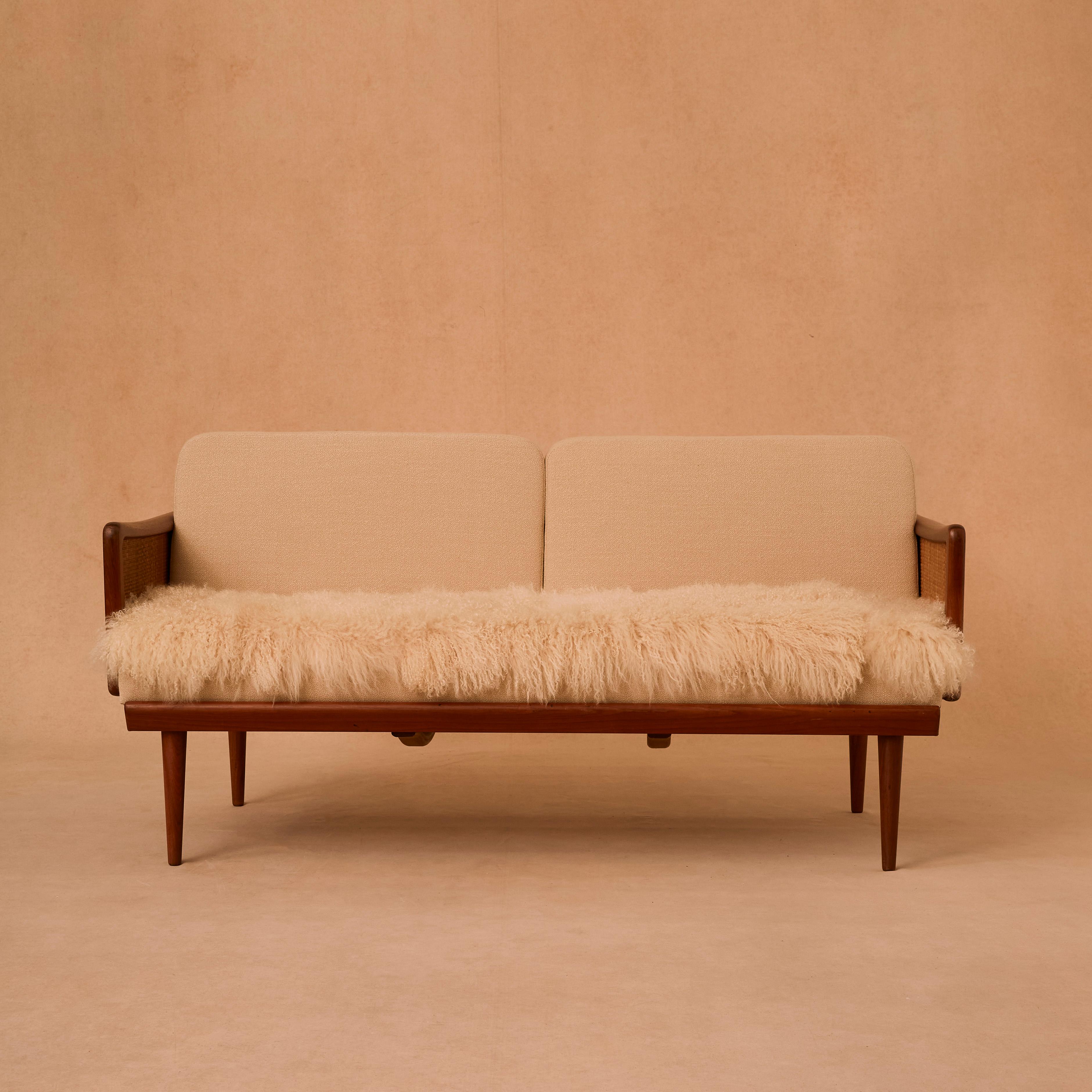 Beautiful sofa or daybed model FD 451 designed by Peter Hvidt & Orla Mølgaard-Nielsen. Produced by France & Søn in Denmark. Teak frame, with woven cane details. Newly upholstery made with Classic Kvadrat wool fabric and Mongolian sheep skin. The