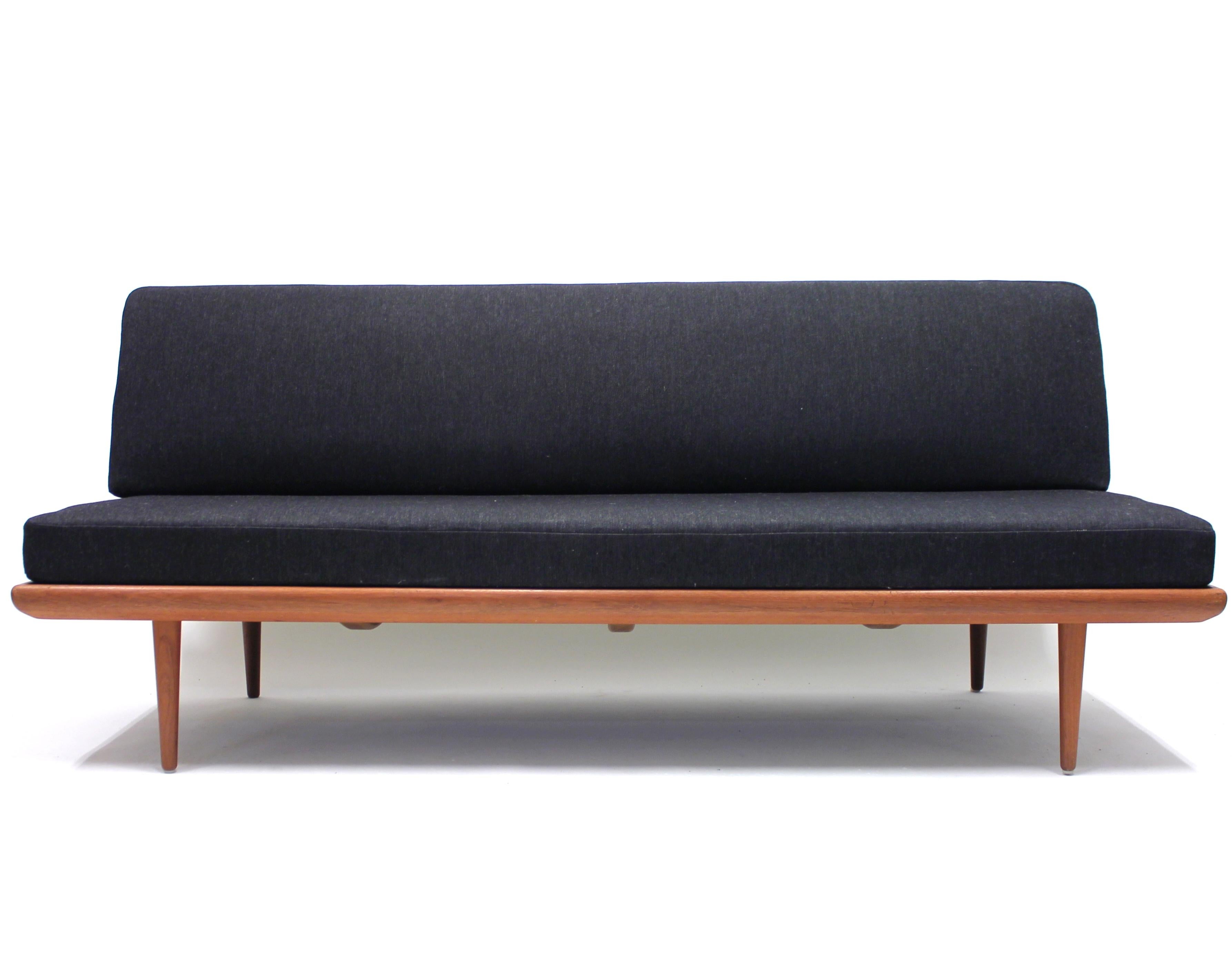 Sofa/daybed model Minerva designed by Danish duo Peter Hvidt & Orla Mølgaard-Nielsen in 1953. Original dark grey fabric on a teak frame. The Minerva series is a whole series of sofas in different sizes and with different armrest options (also