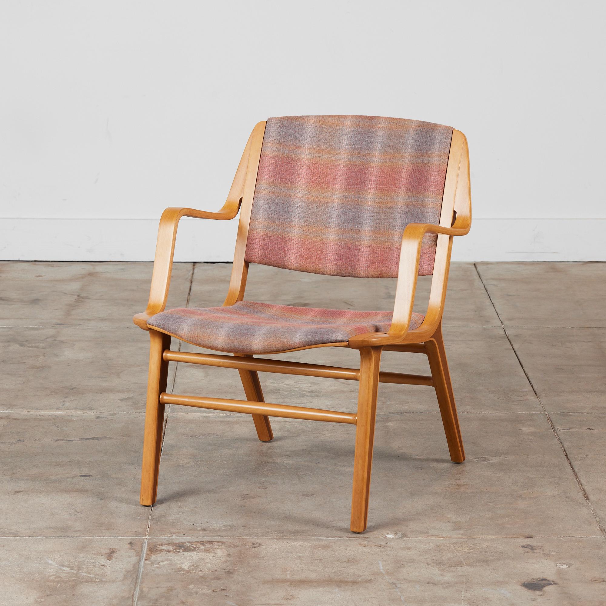 Originally designed in 1947 by Peter Hvidt & Orla Mølgaard Nielsen for Fritz Hansen, Denmark. This chair, made in the 1960s, features a bent beechwood frame with curved armrests. The legs have a stunning exposed teak detailing on their sculpted