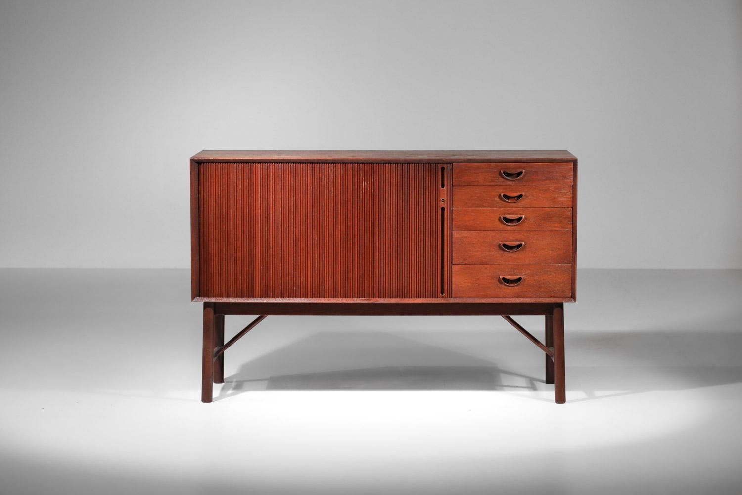 Danish sideboard from the 60s, designed by Danish designers Peter Hvidt and Orla Mølgaard-Nielsen. Solid teak structure, magnificent straight tail assembly on the sides. Composed of a column of 5 drawers on the right part and a sliding curtain door