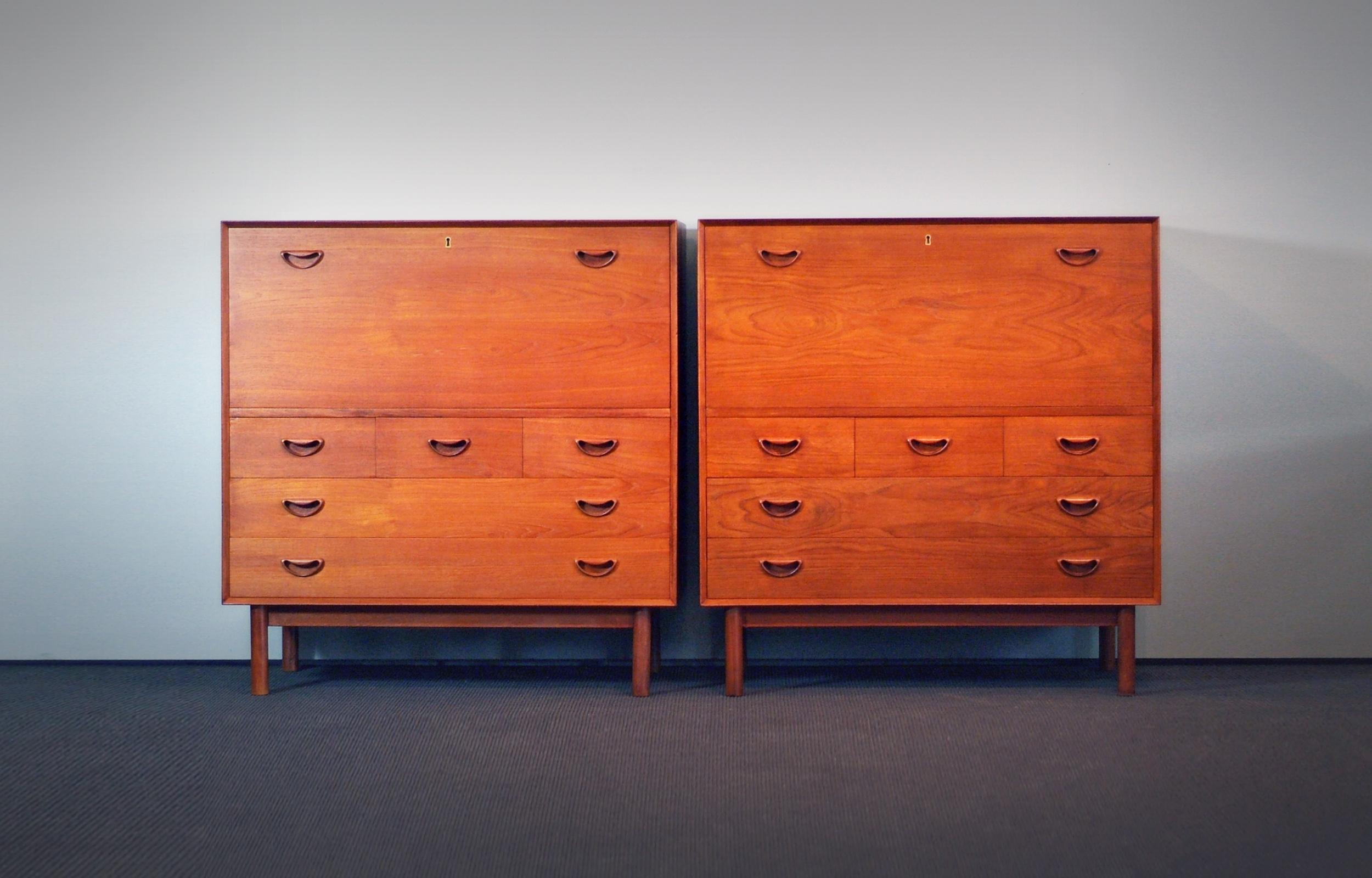 Rare cabinets, chest of drawers or pull out Secretary top. Made of solid teak. One with pictured drawers, 1 with small shelves right and left inside the opened upper cabinet part. Wonderful details and beautiful grained wood and patina.

Wonderful