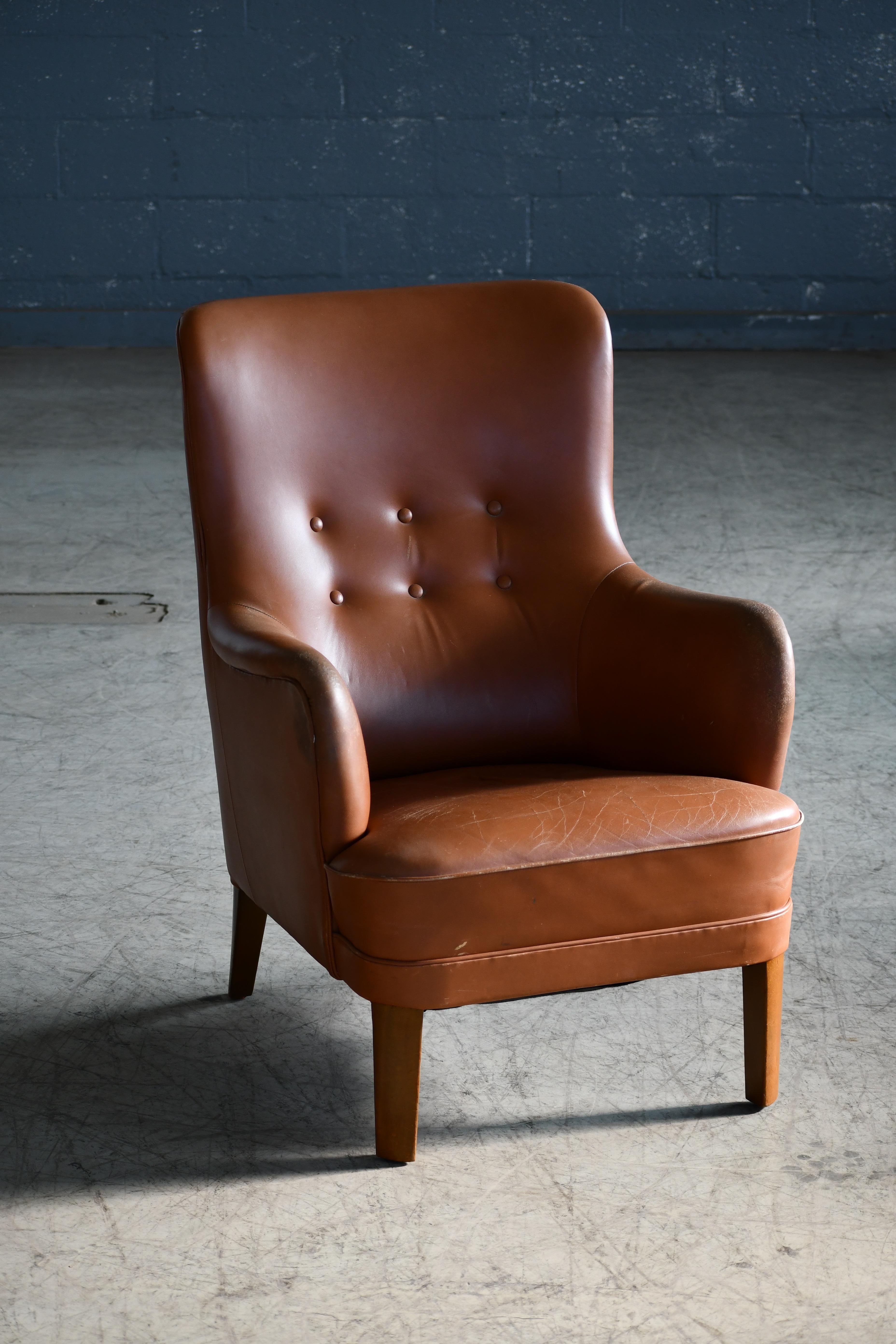 Charming and very elegant Classic Danish lounge chair by Peter Hvidt and Orla Molgaard-Nielsen. Simple yet very refined design lines and very comfortable to sit in even for a tall person. Beechwood frame and coil springs in the seat. Original brown