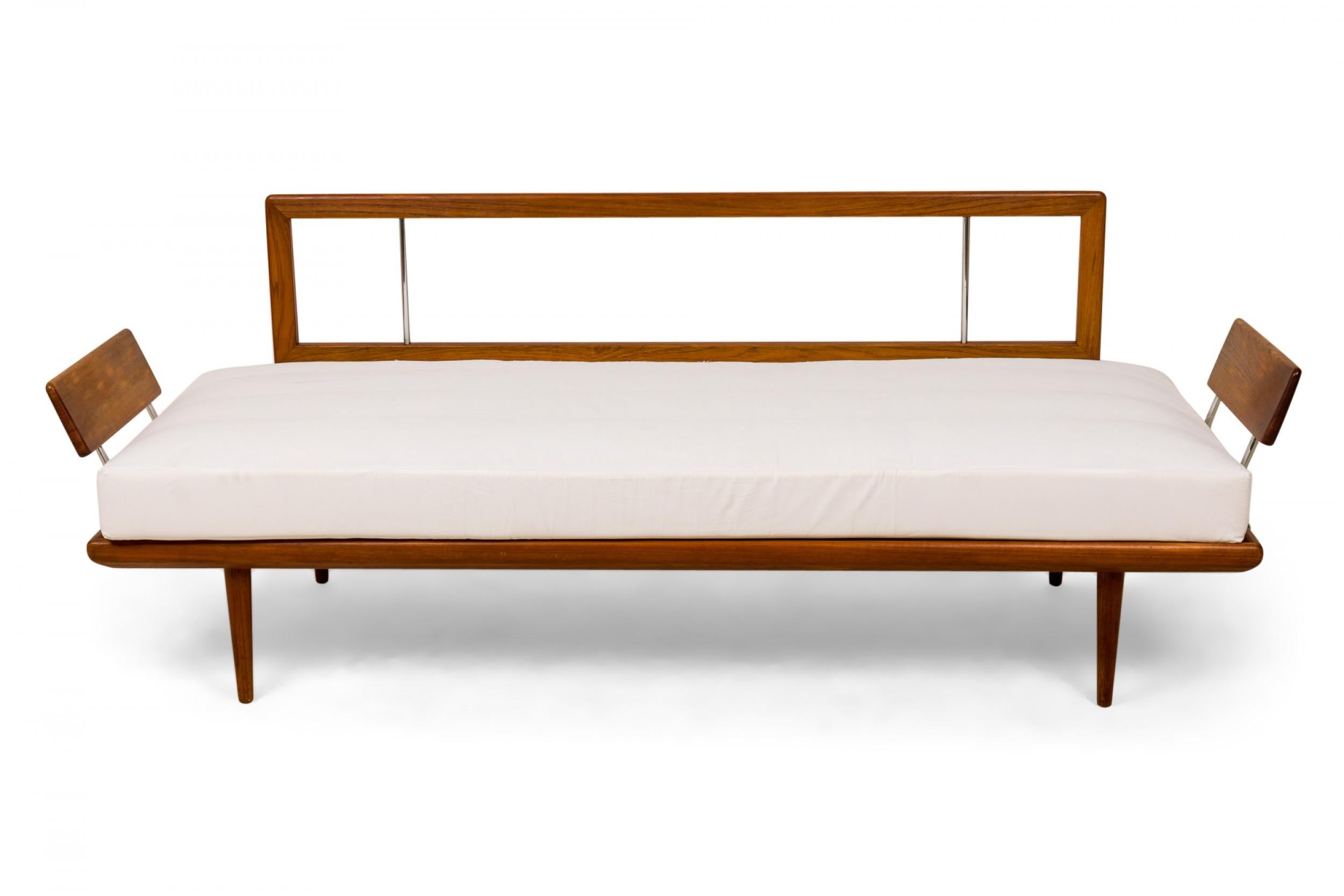 Danish Mid-Century (1960s) 'Minerva' teak sofa with an open framed teak wood back, teak paddle arms anchored to the base frame with chrome bars, and an off-white fabric seat cushion. (PETER HVIDT & ORLA MØLGAARD-NIELSEN)
 
