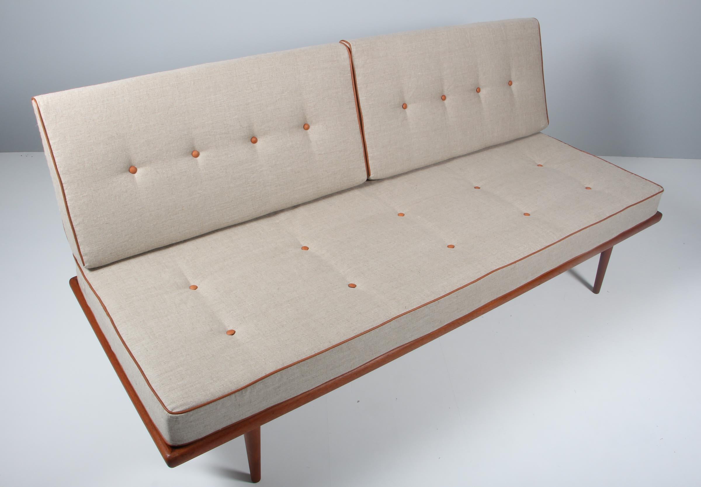 Peter Hvidt & Orla Mølgaard Nielsen daybed with solid teak frame. With backrest.

New upholstered cushion with canvas and cognac aniline leather details.

Made by France & Daverkosen in the 1960s.