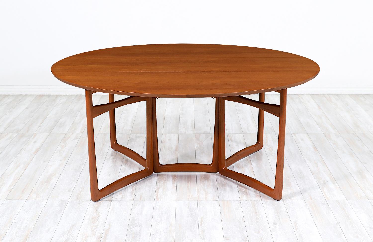 Stunning modern dining table by the iconic Danish duo, Peter Hvidt and Orla Mølgaard Nielsen for France & Søn in Denmark circa 1950s. Quintessentially Danish, this dining table features a solid teak base with a sophisticated design, making it