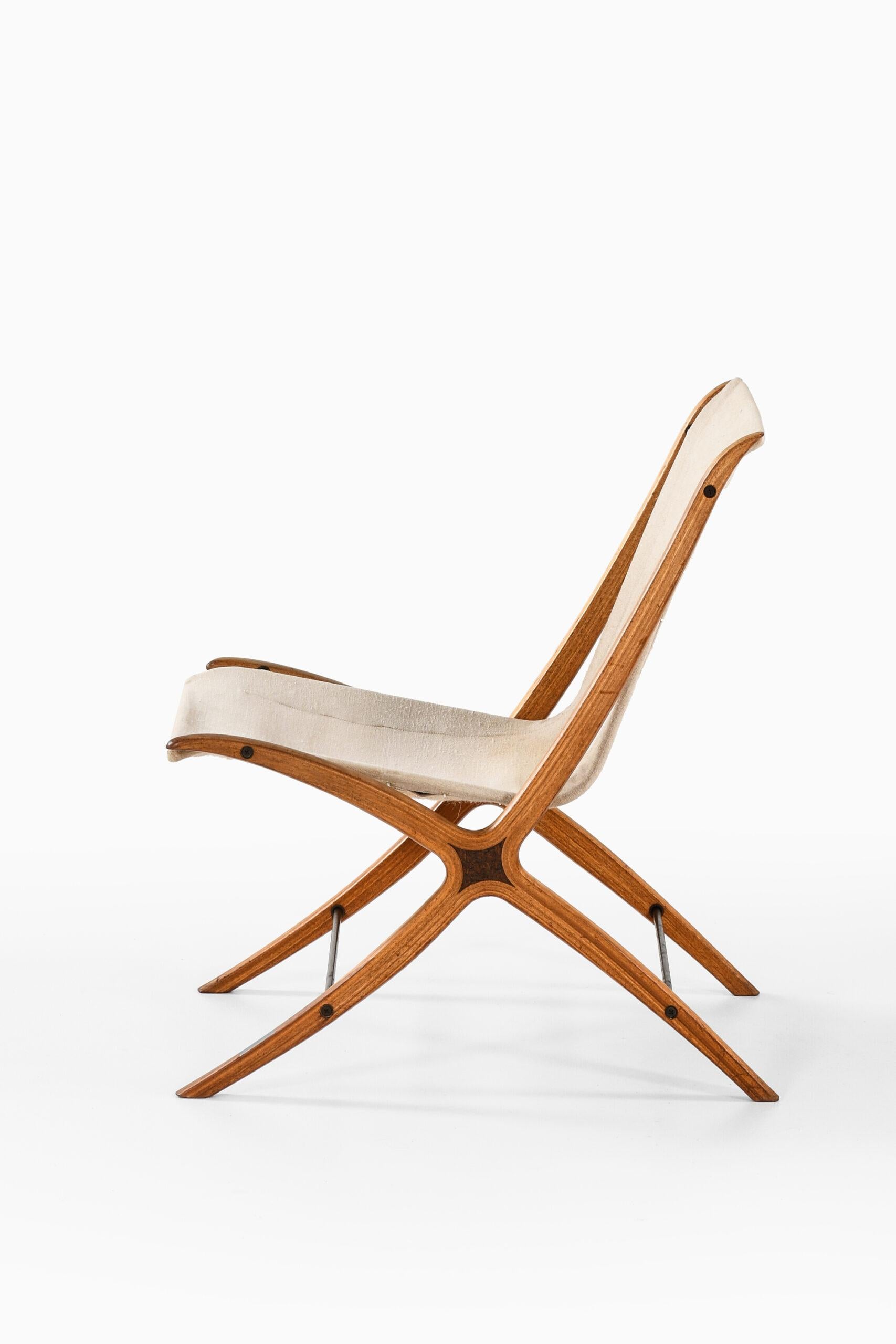 Rare easy chair model X-chair / FH-6135 designed by Peter Hvidt & Orla Mølgaard-Nielsen. Produced by Fritz Hansen in Denmark.