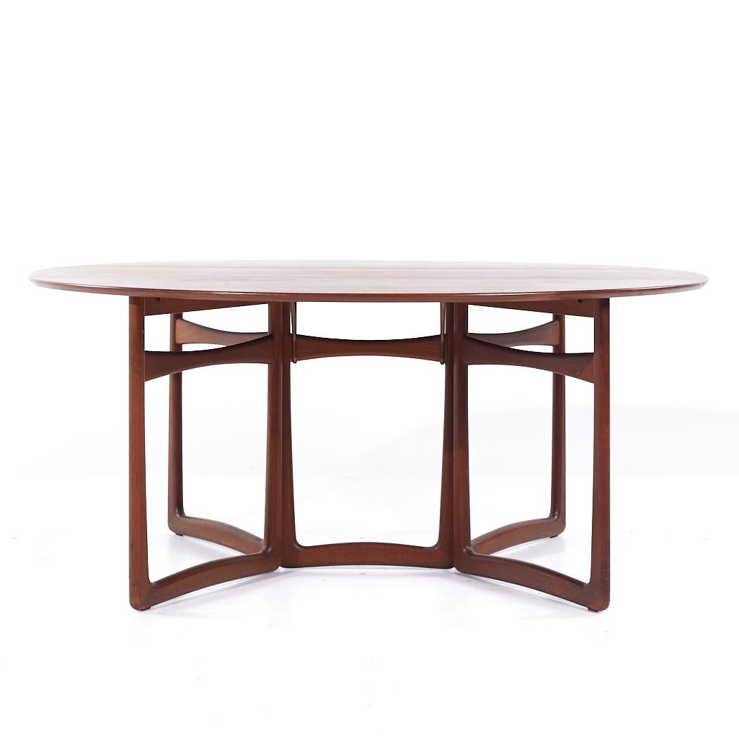 Peter Hvidt and Orla Mølgaard Nielsen for France and Son Mid Century Teak Drop Leaf Dining Table

This table measures: 16 wide x 64 deep x 28.25 inches high, with a chair clearance of 27.5 inches, each drop leaf measures 19.75 inches wide, making a