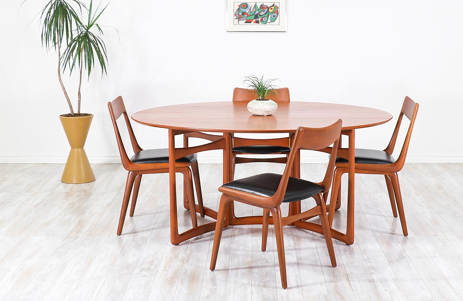 Stunning modern dining table by the iconic Danish duo, Peter Hvidt and Orla Mølgaard Nielsen for Søborg Møbelfabrik in Denmark, circa 1950s. Quintessentially Danish, this dining table features a solid teak base with a sophisticated design, making it