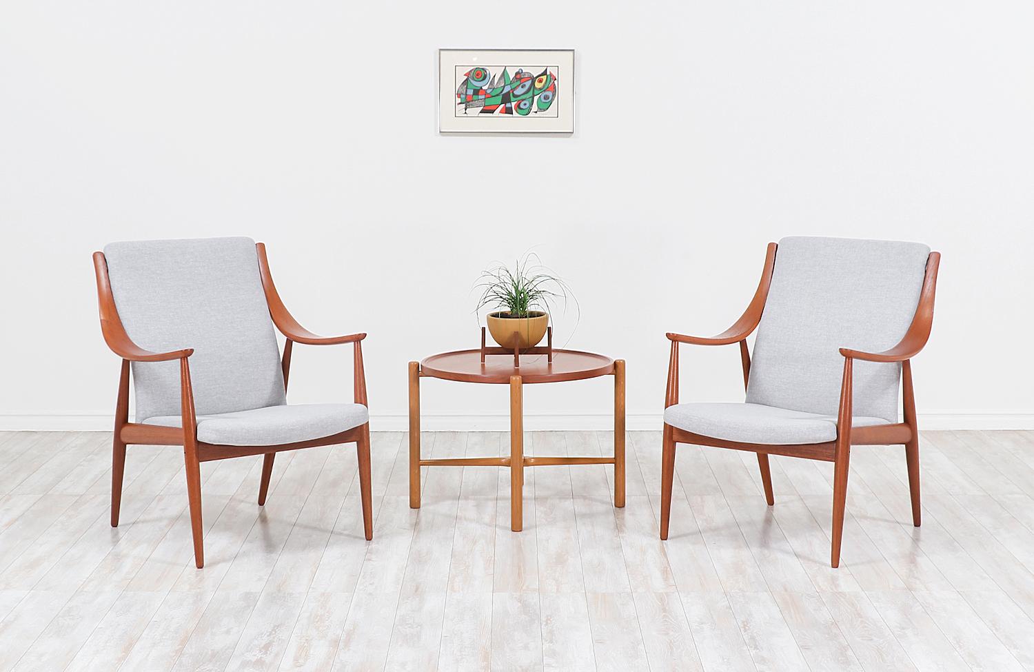 Pair of stunning Peter Hvidt & Orla Mølgaard-Nielsen lounge chairs designed for France & Søn in Denmark circa 1950s. This design uses quality teak wood and a few studio Craft techniques including laminated bentwood curvilinear arms and beautifully