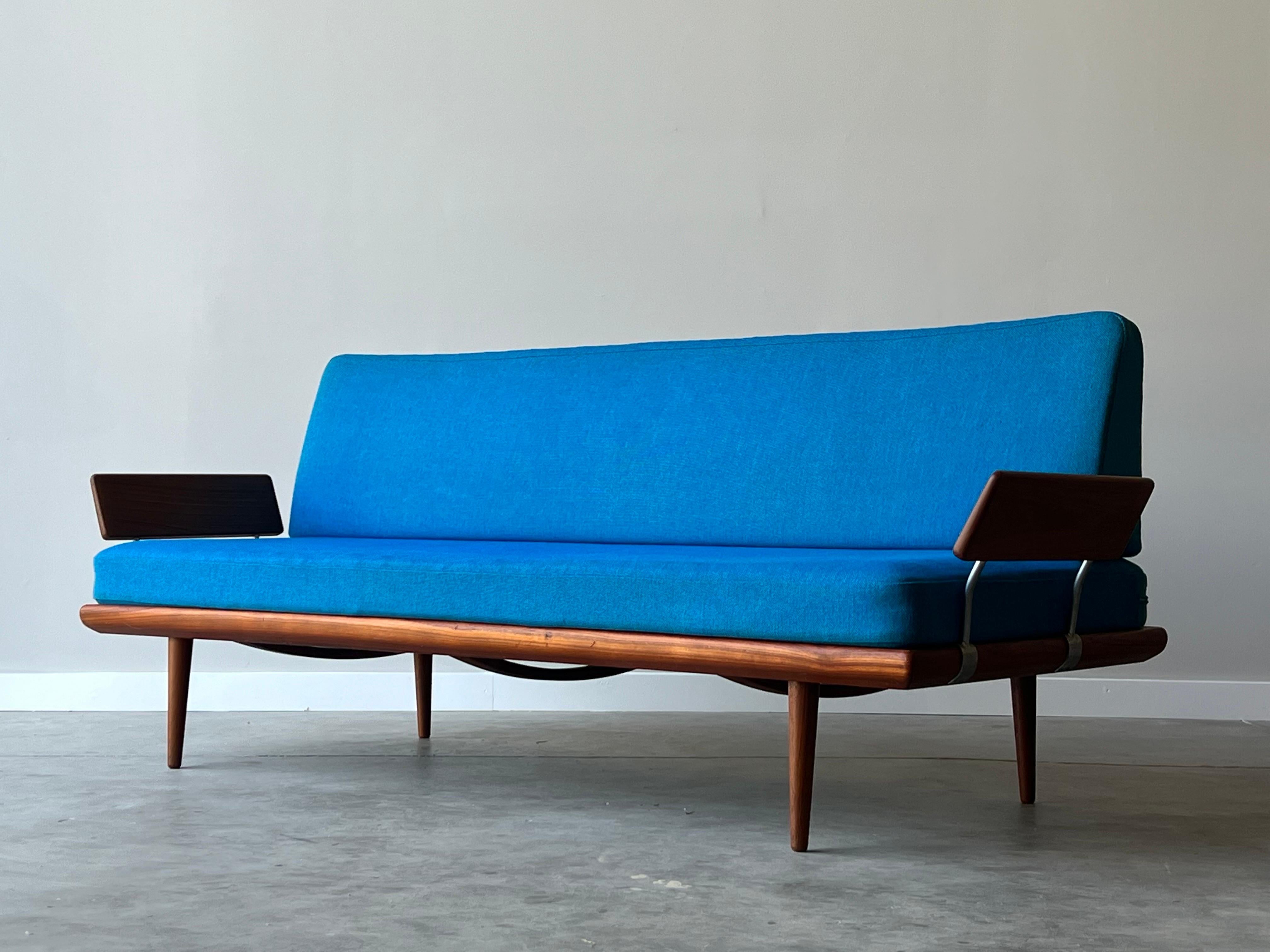 Daybed sofa designed by Peter Hvidt and Orla Mølgaard Nielsen for France and Son, Denmark. This Danish sofa was made circa 1960s with a sturdy teak frame and chrome bar accents. The sofa sits on sleek teak tapered legs with teak paddle arms anchored
