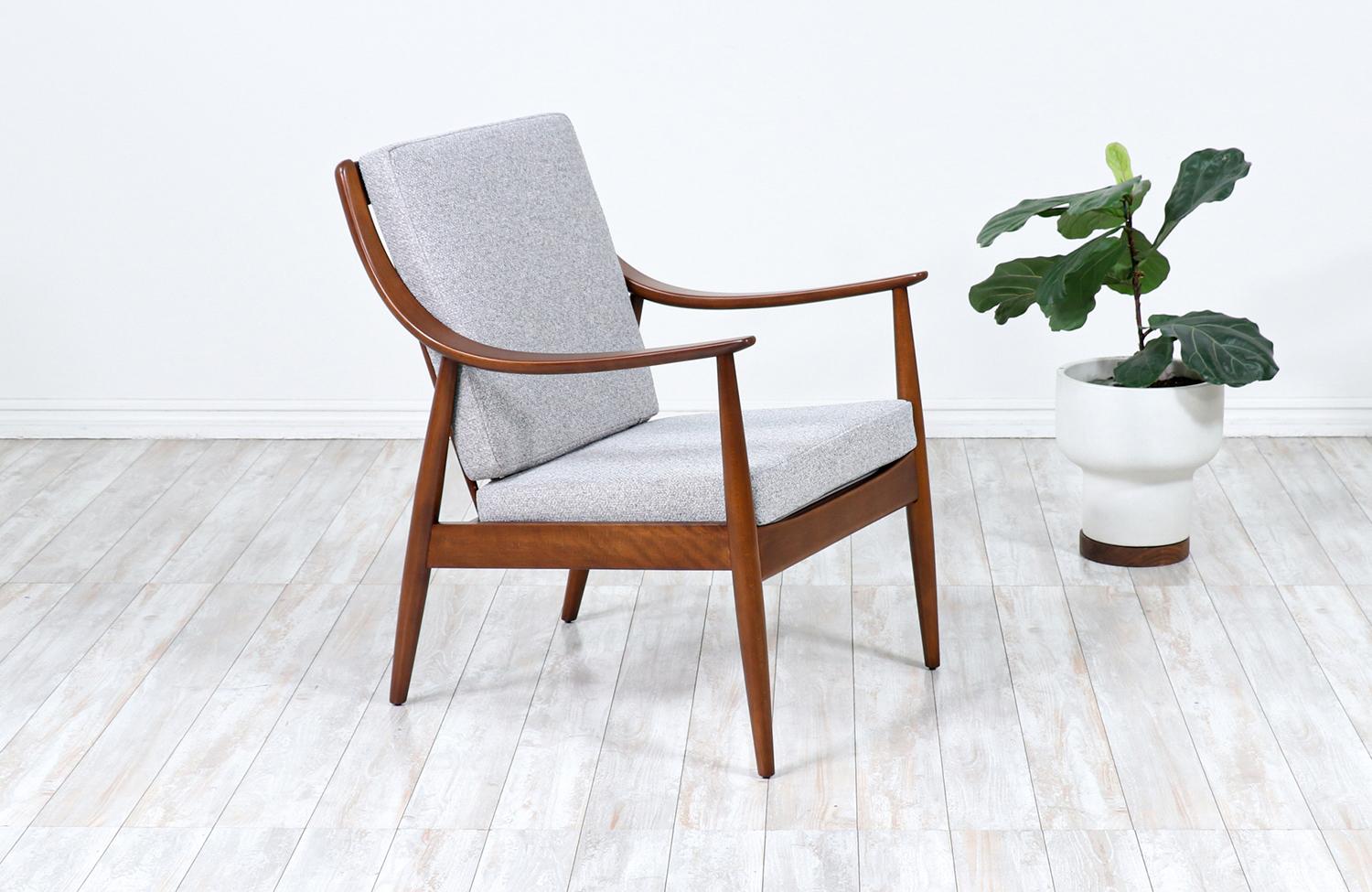 Chaise longue conçue par Peter Hvidt & Orla Mølgaard-Nielsen pour France & Daverkosen au Danemark vers les années 1950. Ce magnifique modèle FD-146 présente un cadre en bois de hêtre teinté noyer avec des accoudoirs incurvés. Le dossier comporte