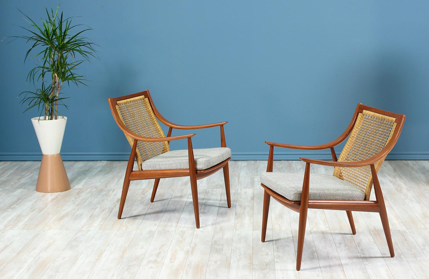 Pair of lounge chairs designed by Peter Hvidt & Orla Mølgaard-Nielsen for France & Daverkosen in Denmark circa 1950’s. Crafted using a few studio techniques: laminated bentwood curvilinear arms and beautifully exposed joinery, this pair of iconic