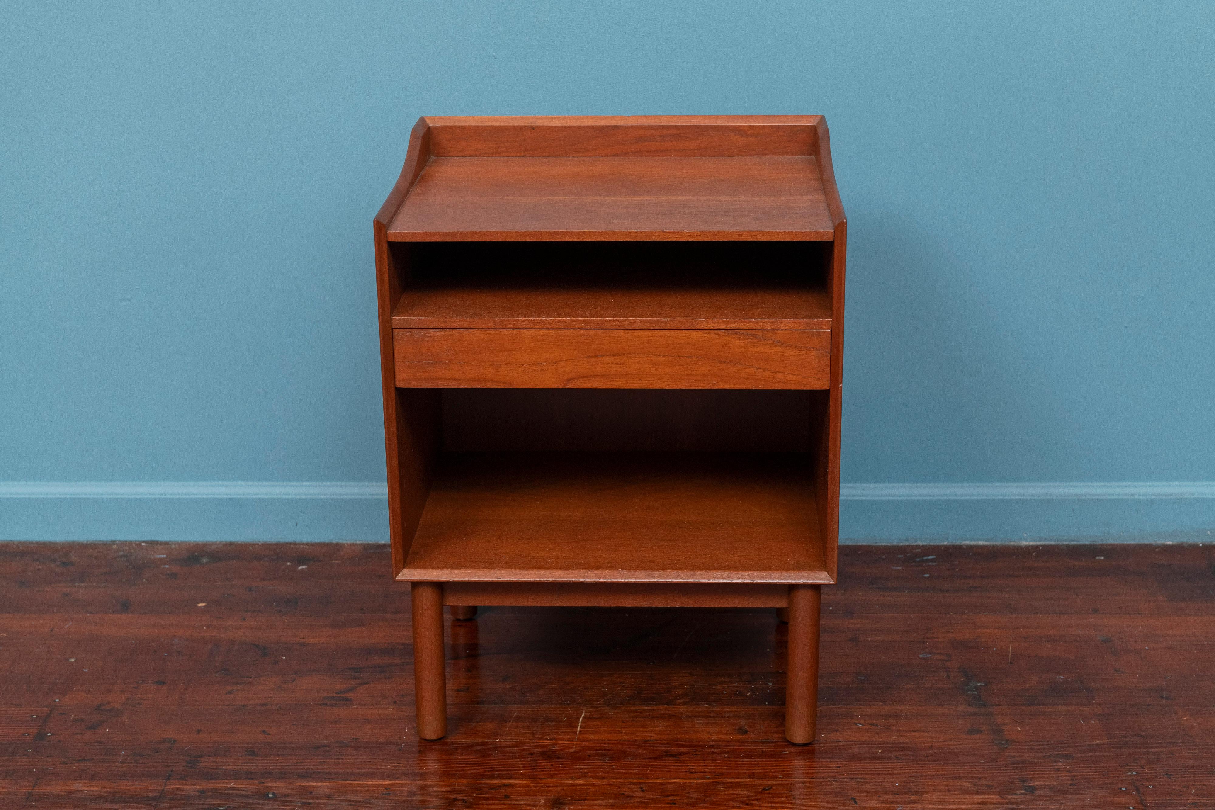 Peter Hvidt & Orla Mølgaard-Nielsen design solid teak nightstand. High quality materials and construction featuring a gallery top, single drawer and shelf. Newly refinished and ready ti install and enjoy.
