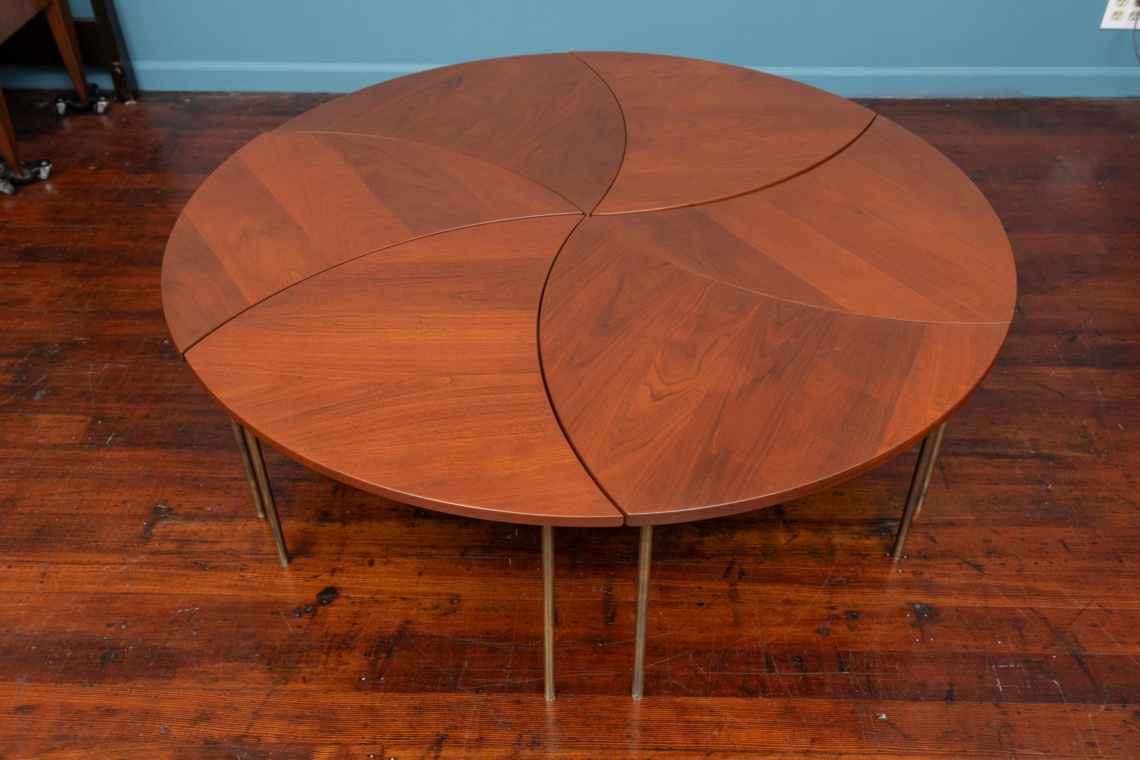 Peter Hvidt and Orla Molgaard-Nielsen design pinwheel form coffee table model #523 by France & Son, Denmark. Comprising a set of six individual solid teak tables with brass legs made with high quality materials and construction. Circular diameter as