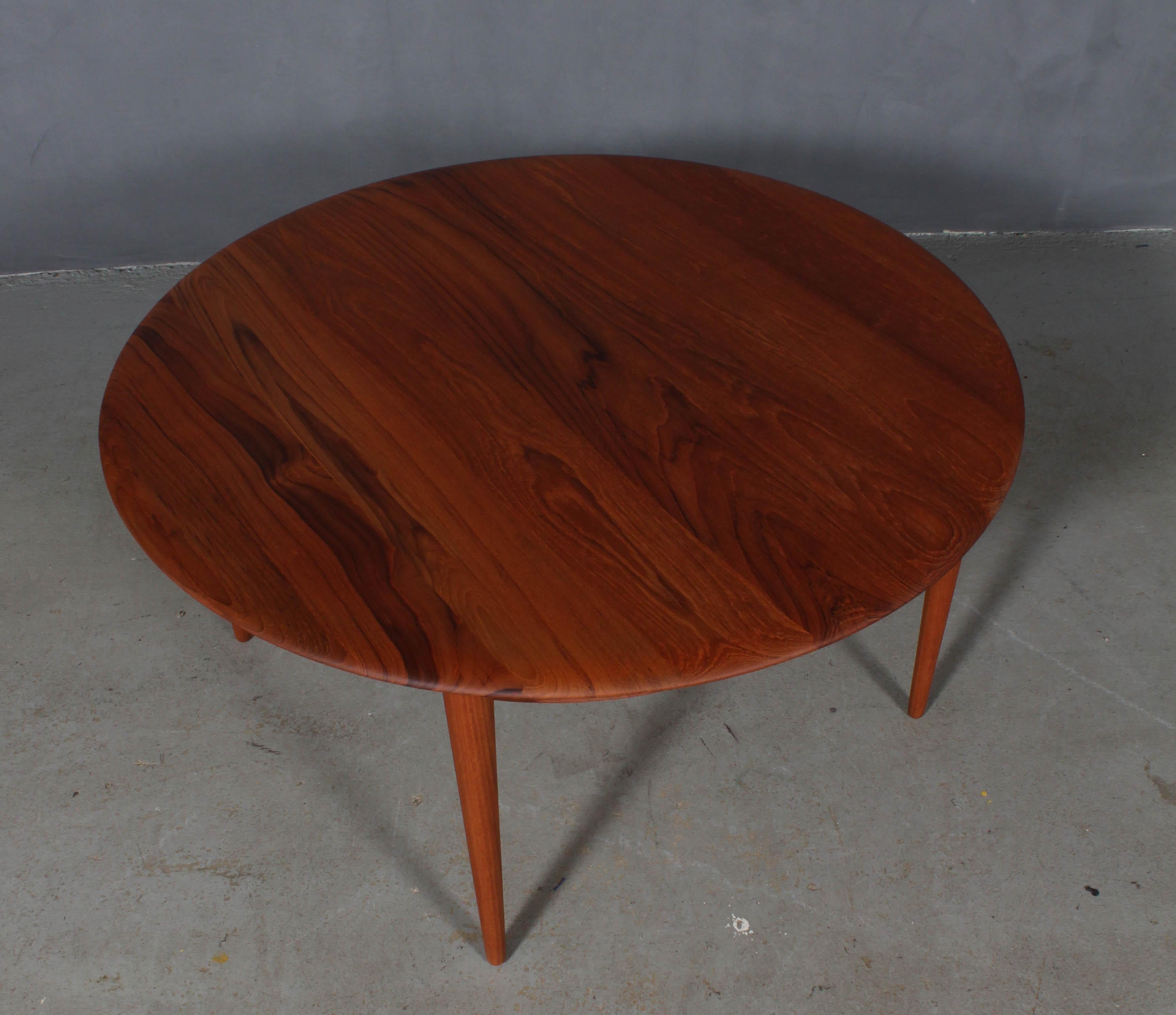 Peter Hvidt & Orla Mølgaard Nielsen sofa table in sold teak.

Cane shelf.

Made by France & Daverkosen in the 1960s.