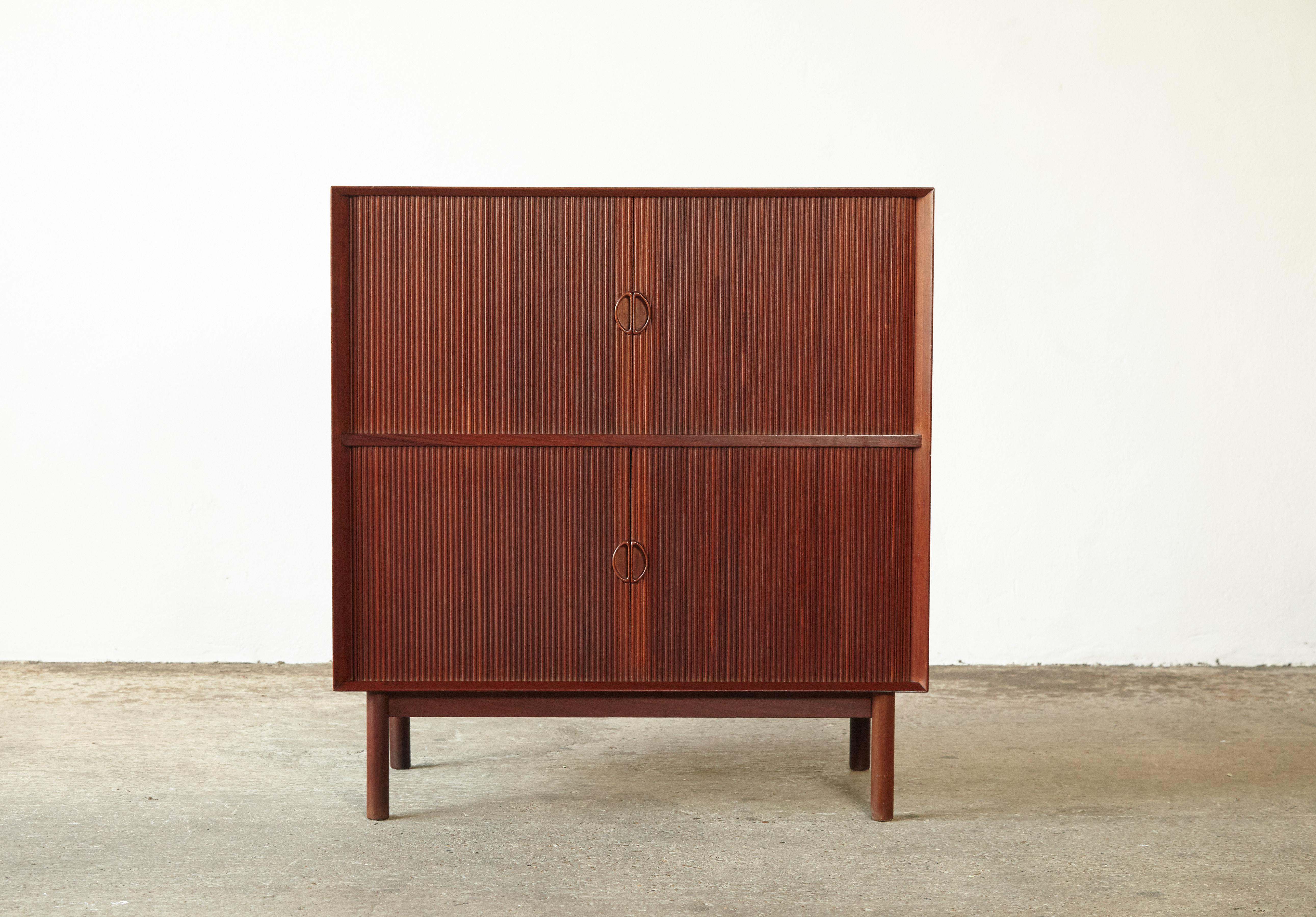 Peter Hvidt & Orla Mølgaard-Nielsen Double Tabour Door Cabinet, for Søborg Møbler, Denmark, 1958. Solid teak with tambour doors, it has a finger jointed cabinet on round legs. Very good original vintage condition, minor signs of use and wear.

  