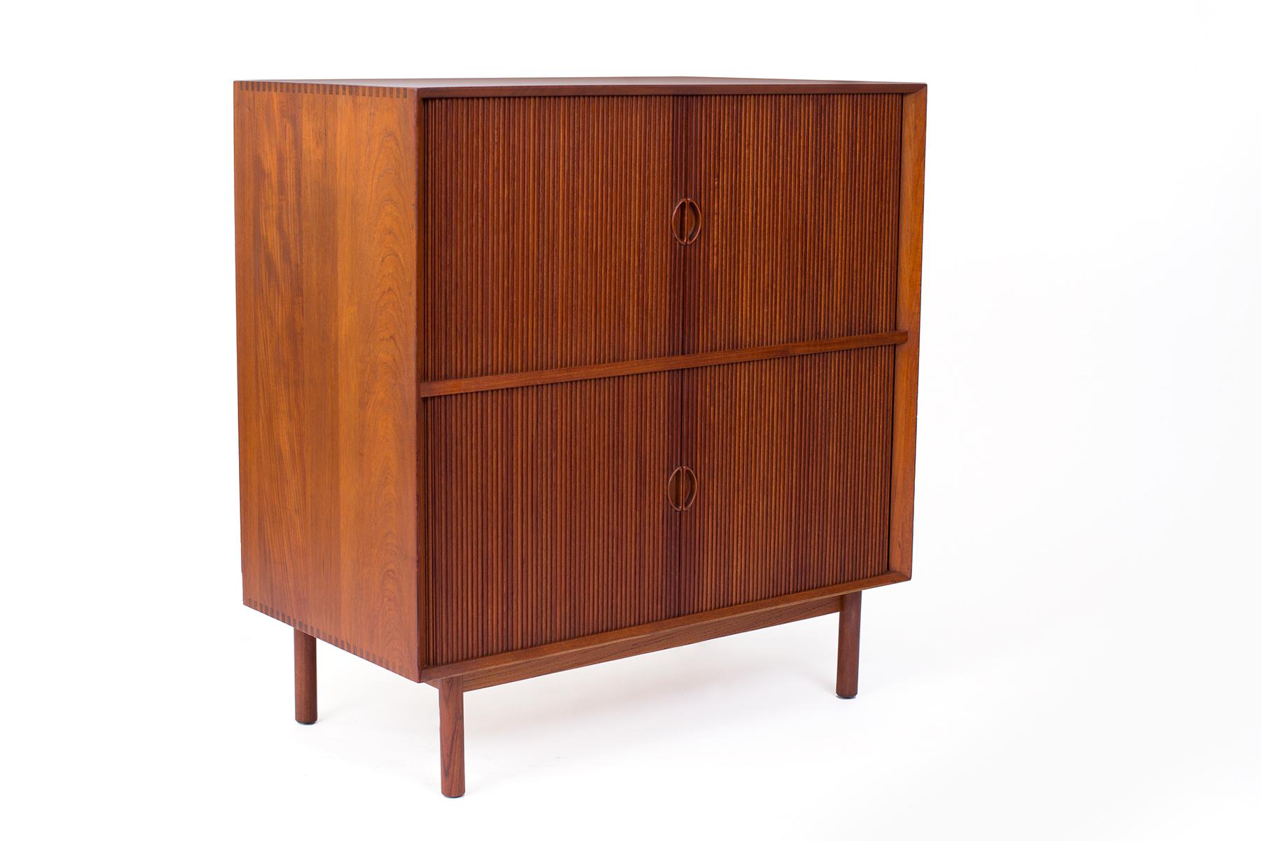 Peter Hvidt and Orla Mølgaard Nielsen teak chest, circa late 1950s. This all original example has exposed finger joints and is solid teak. The top and bottom have tambour doors.