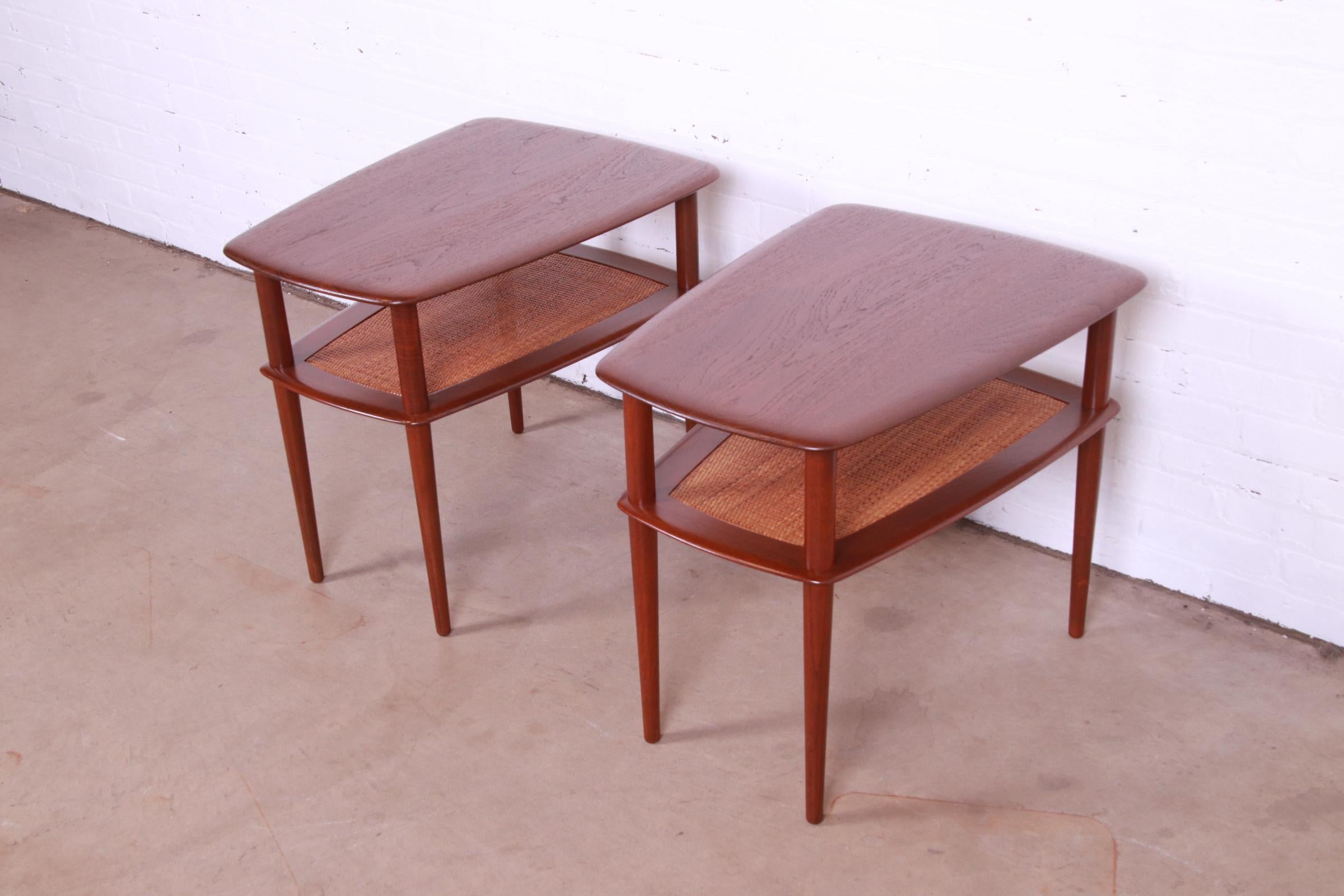 An exceptional pair of mid-century Danish Modern two-tier side tables or end tables

By Peter Hvidt and Orla Mølgaard-Nielsen for France & Søn

Denmark, 1950s

Sculpted teak, with caned lower shelf.

Measures: 20.75