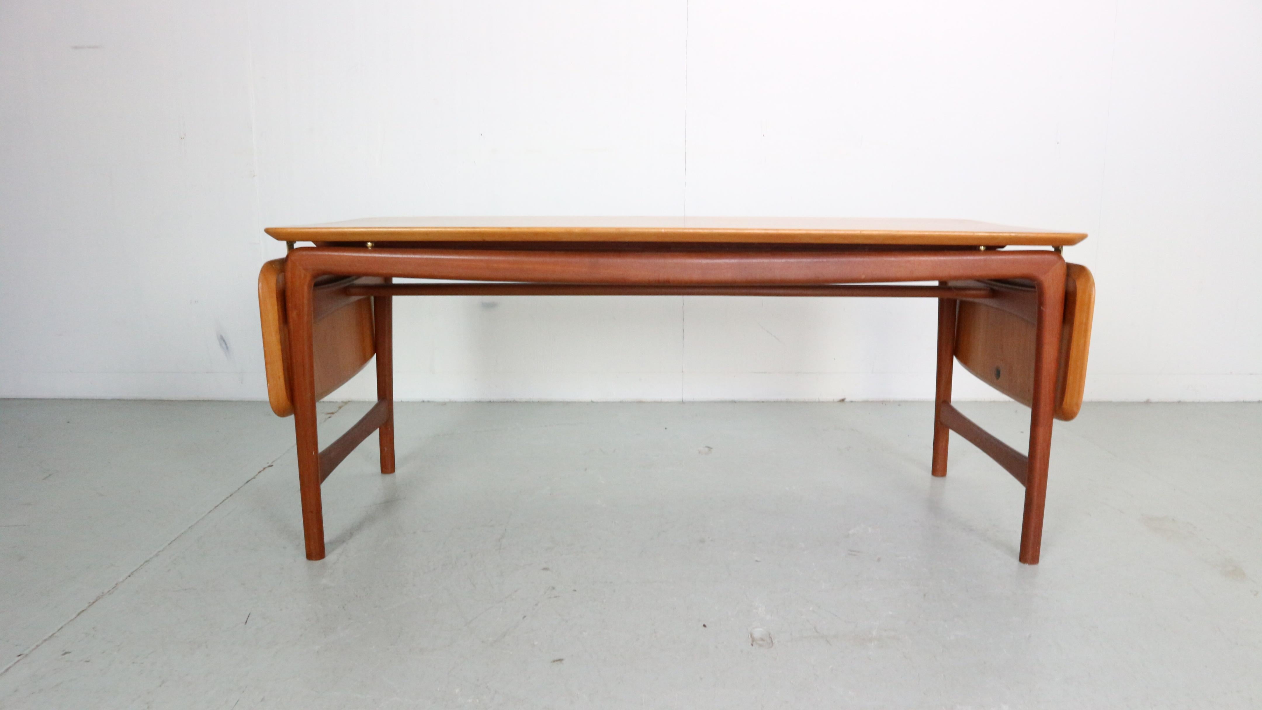 Vintage solid teak table designed by the famous Danish designer duo Peter Hvidt & Orla Mølgaard-Nielsen for France & Daverkosen. This high-end design table features a typical mid-century Danish design, gorgeous solid teak wood, messing fittings and