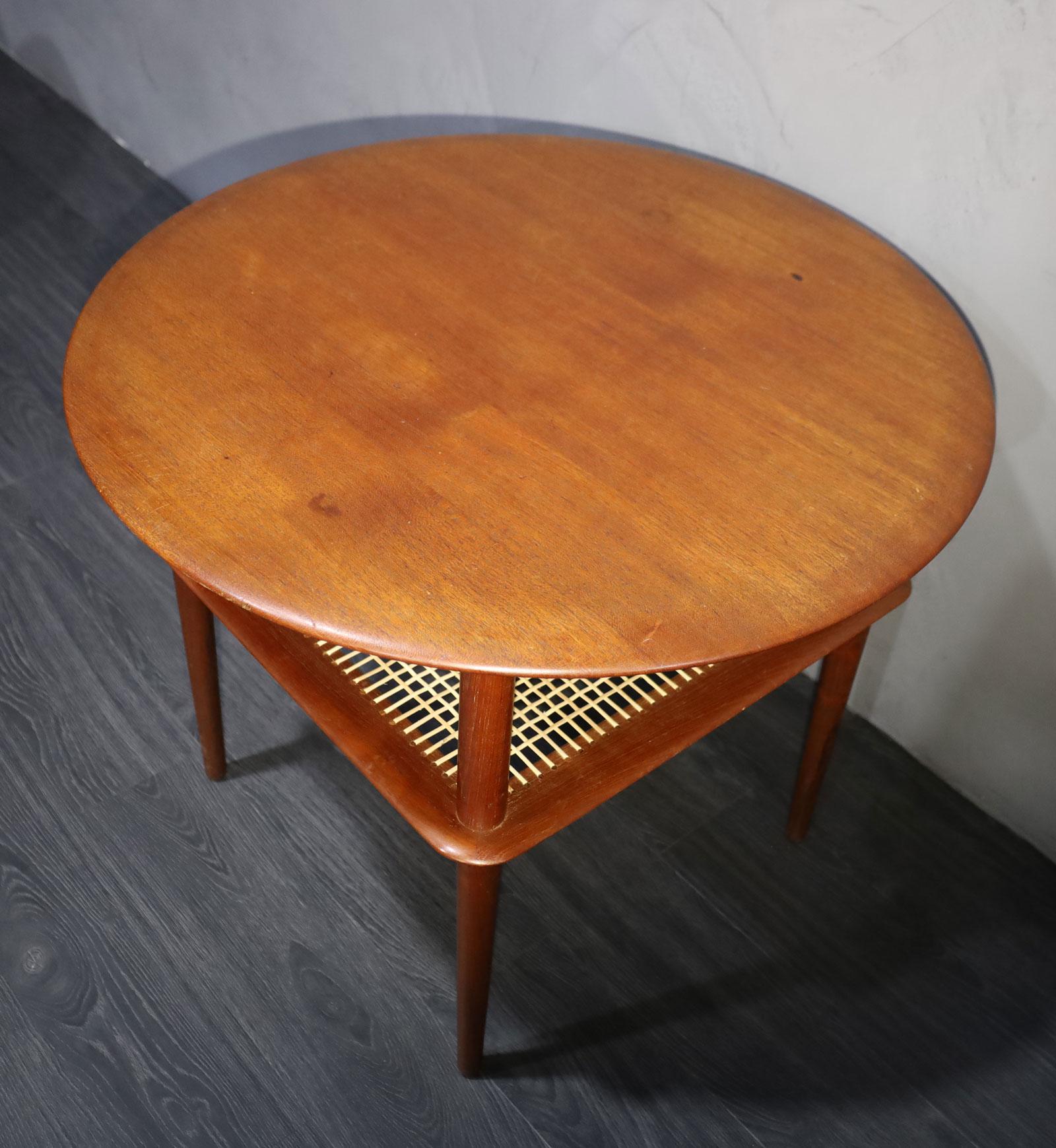 Teak side table with a cane lower shelf. Design by Peter Hvidt and Orla Mølgaard-Nielsen for France and Daverkosen and distributed by John Stuart, Inc in the USA.