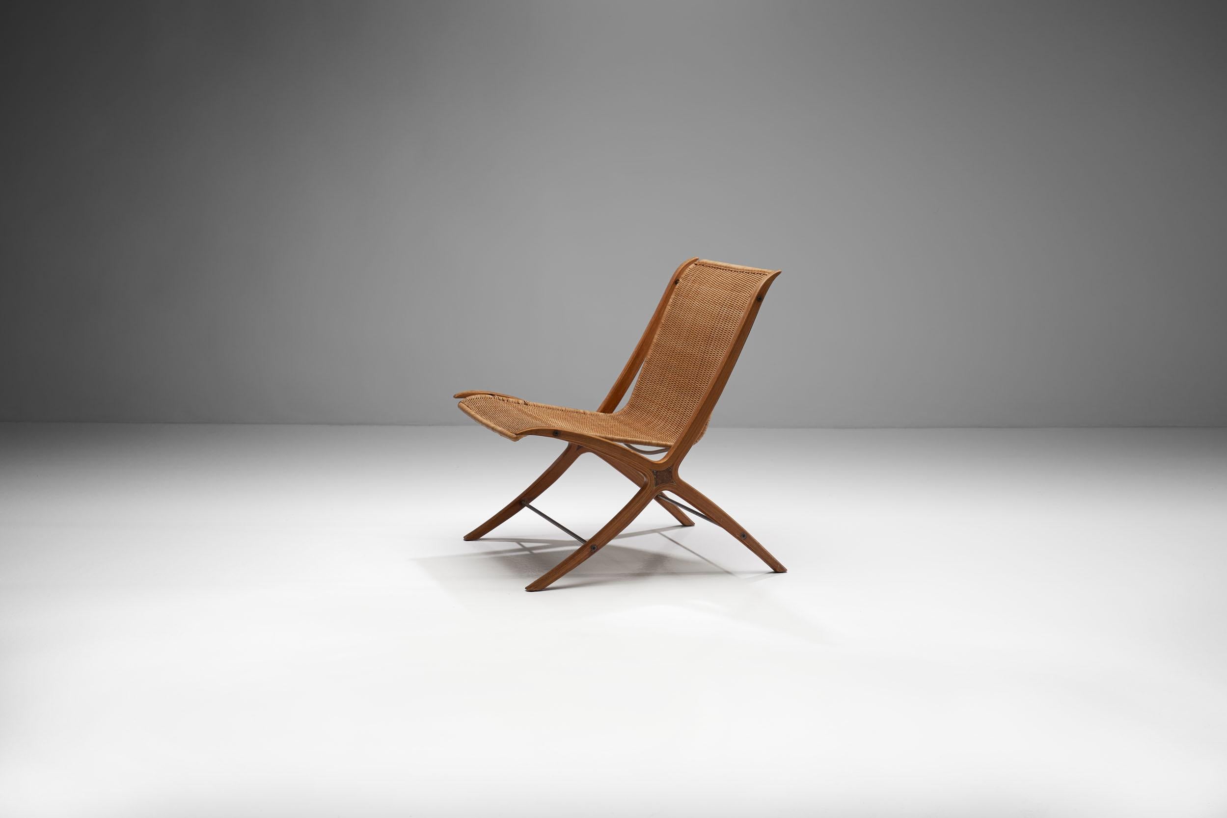 Rare X-chair in rattan and mahogany designed by Peter Hvidt & Orla Mølgaard-Nielsen produced by Fritz Hansen in Denmark, 1950s - 1960s.
This chair by designer duo Peter Hvidt & Orla Mølgaard-Nielsen, is called the X-chair for obvious reasons. Made