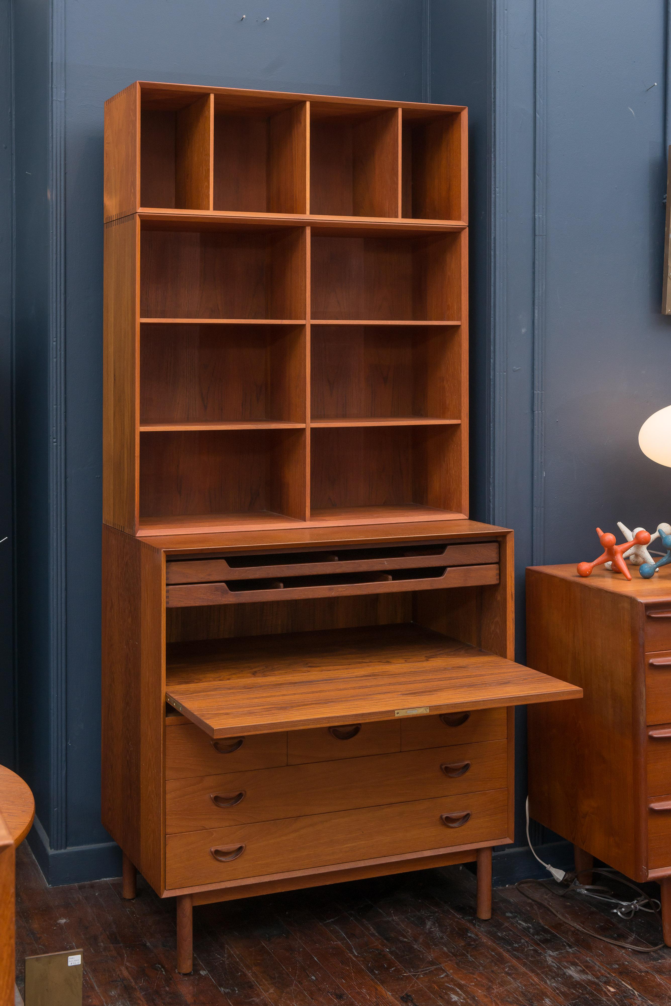 Tall Danish teak secretary bookcase designed by Peter Hvidt & Orla Mølgaard, Denmark. The locking secretary section has two pull out paper trays and five drawers. The upper bookcase has adjustable shelves and is finished off with a file or book