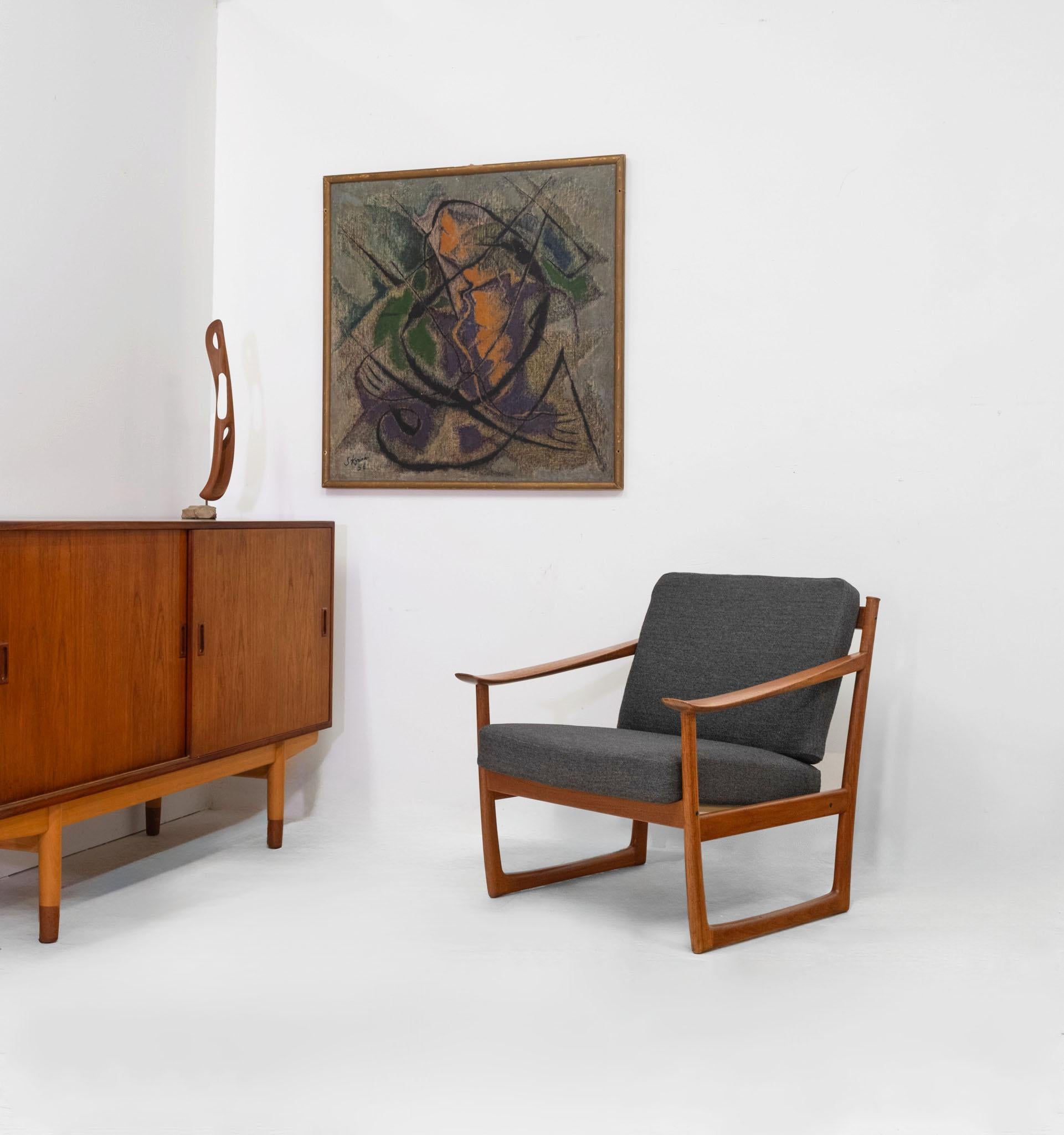 Teak sleigh leg lounge chair by Danish architect-designers Peter Hvidt & Orla Mølgaard for France & Son. Model FD130. Labelled. Circa 1960.

The chair having the original charcoal grey wool fabric, with sprung box cushions. The under seat frame is