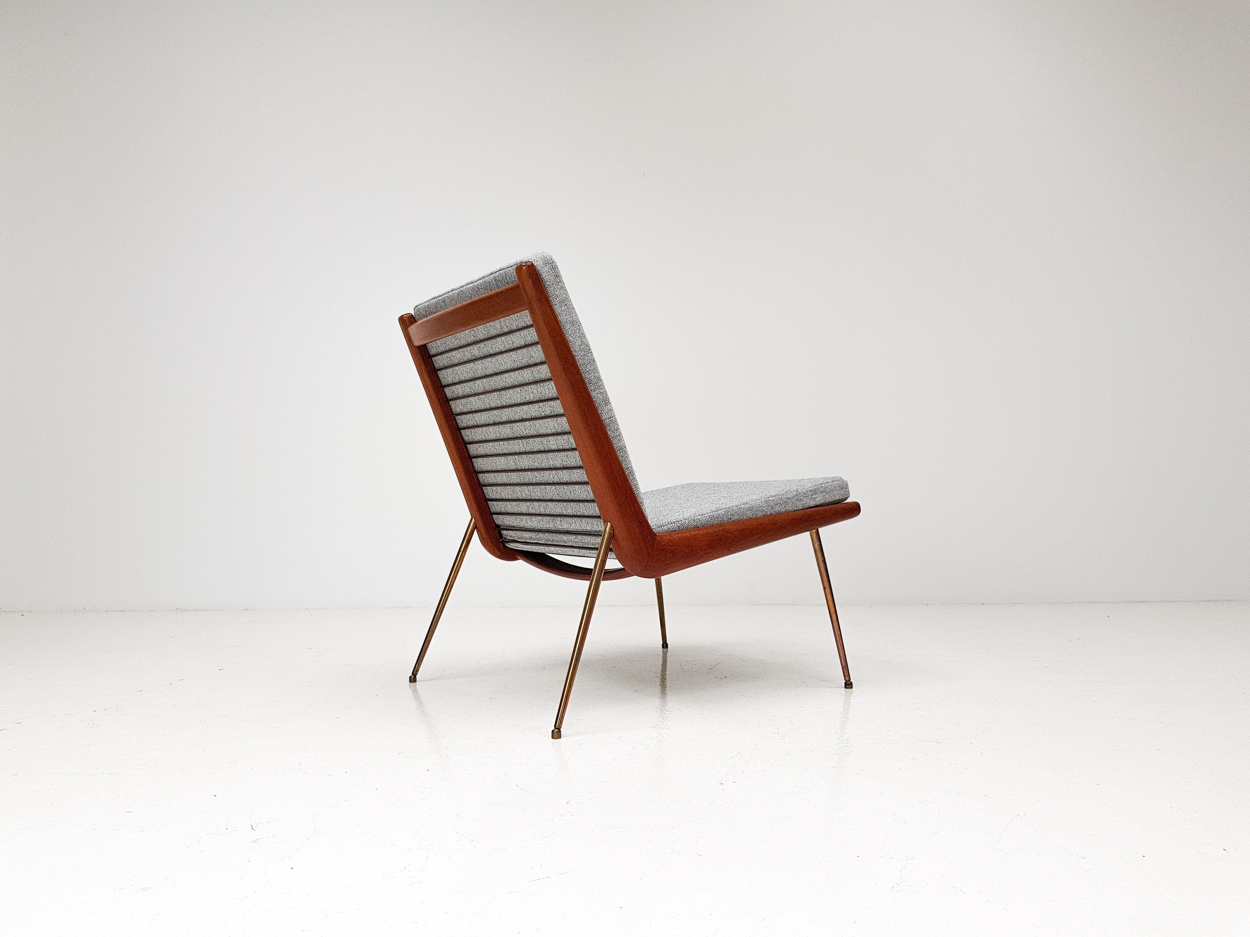 A Peter Hvidt & Orla Molgaard-Nielsen designed FD-159 'Boomerang' lounge chair for France & Son, Denmark, 1950s.  THE MODEL FEATURING ARMS

The chair has a boomerang-shaped frame in teak from which its name derives, brass legs, new cushions and new