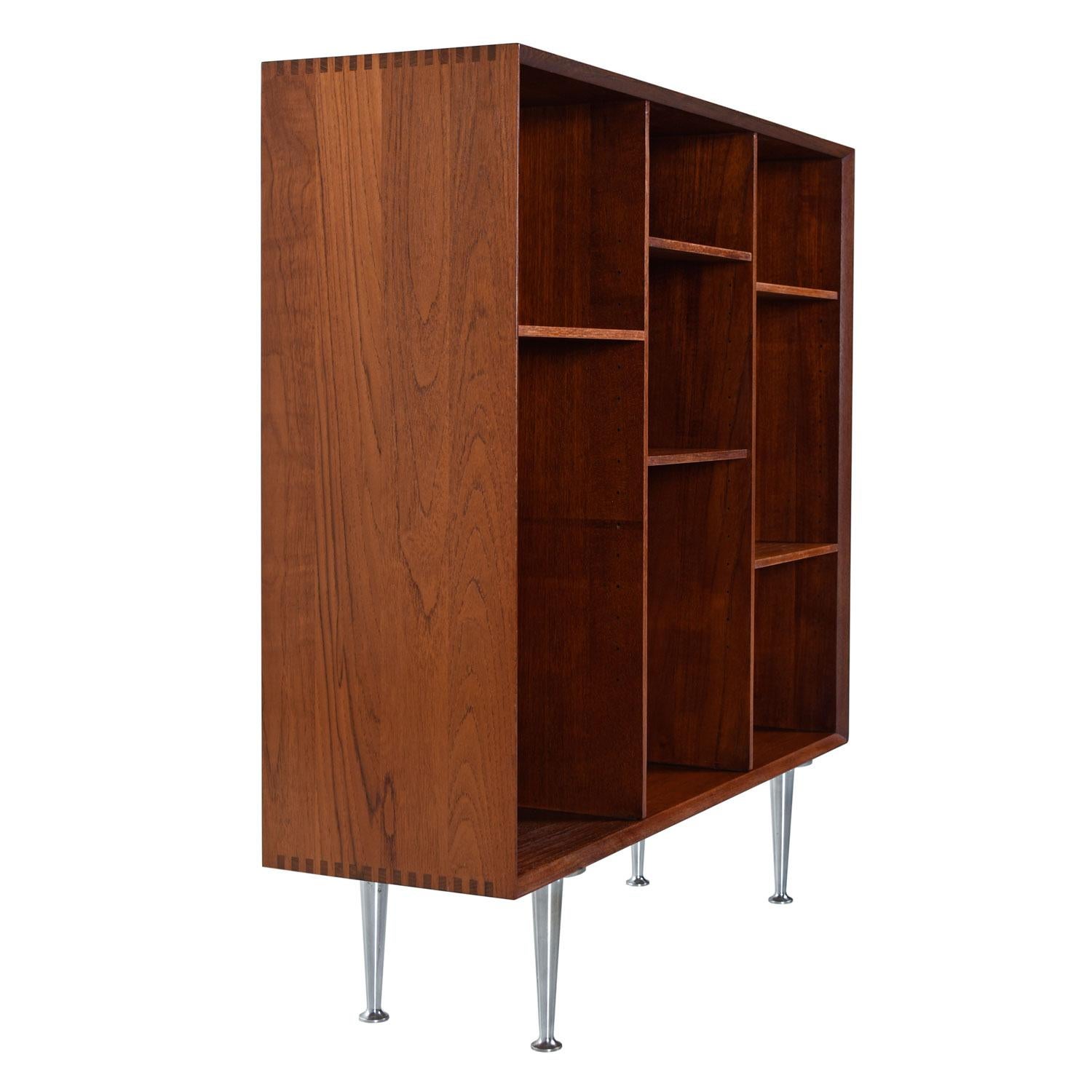 Designed by Peter Hvidt & Orla Mølgaard-Nielsen for John Stuart. True solid teak, no plywood or MDF (except for shelves and back panel). The finger joinery is clearly visible from a distance and adds to the overall charm while illustrating