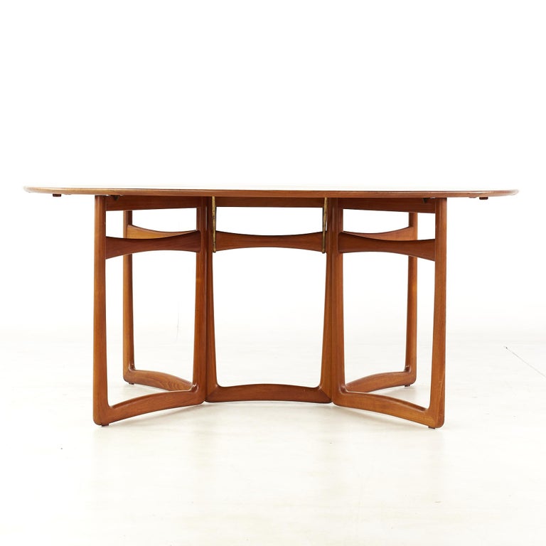 Peter Hvidt and Orla Molgaard Nielsen for France and Son mid century teak drop leaf dining table

This table measures: 55.5 wide x 64 deep x 28.5 high, with a chair clearance of 27.5 inches, each drop leaf measures 19.75 inches

All pieces of