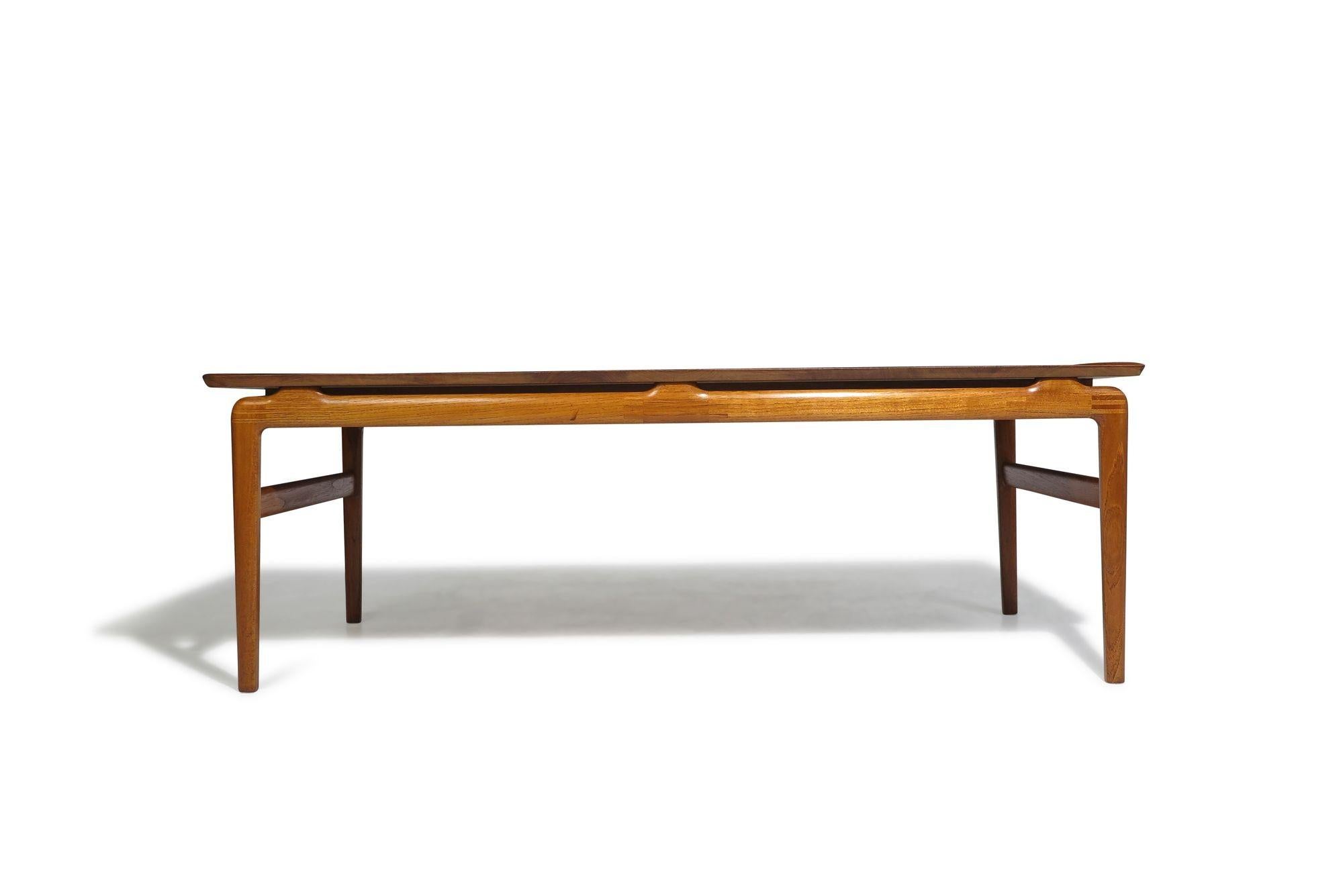 Solid teak coffee table designed by Peter Hvidt & Orla Molgaard Nielsen For France & Son, model 640, 1958 Denmark. Crafted of planks of old growth teak with exposed joinery on legs and apron. Professionally restored in a natural oil