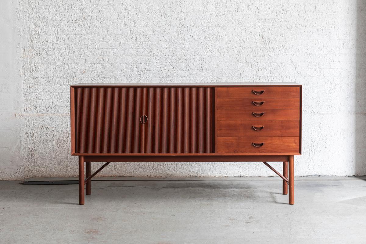 Sideboard designed by Peter Hvidt and Orla Molgaard and produced by Soborg Mobler in Denmark around 1960. A real design classic with a solid teak structure with typical finishes for Hvidt and Molgaard designs. 5 drawers on the right and tambour