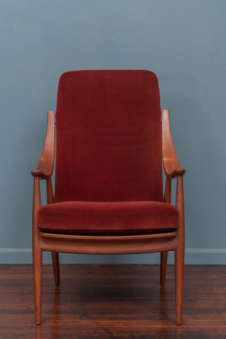 Peter Hvidt & Orla Moregaard design high back armchair for France and Son, Denmark. Rare version of this armchair with sloping teak arms and newer rust velvet upholstery, very comfortable and ready to install.
 